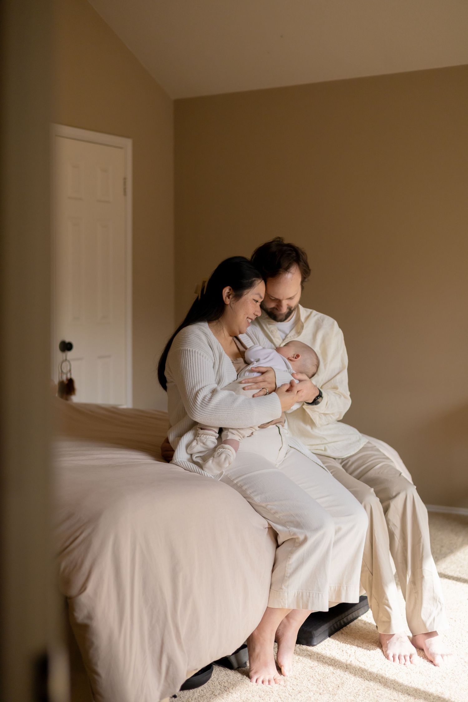 Parents holding their newborn baby during a lifestyle newborn session
