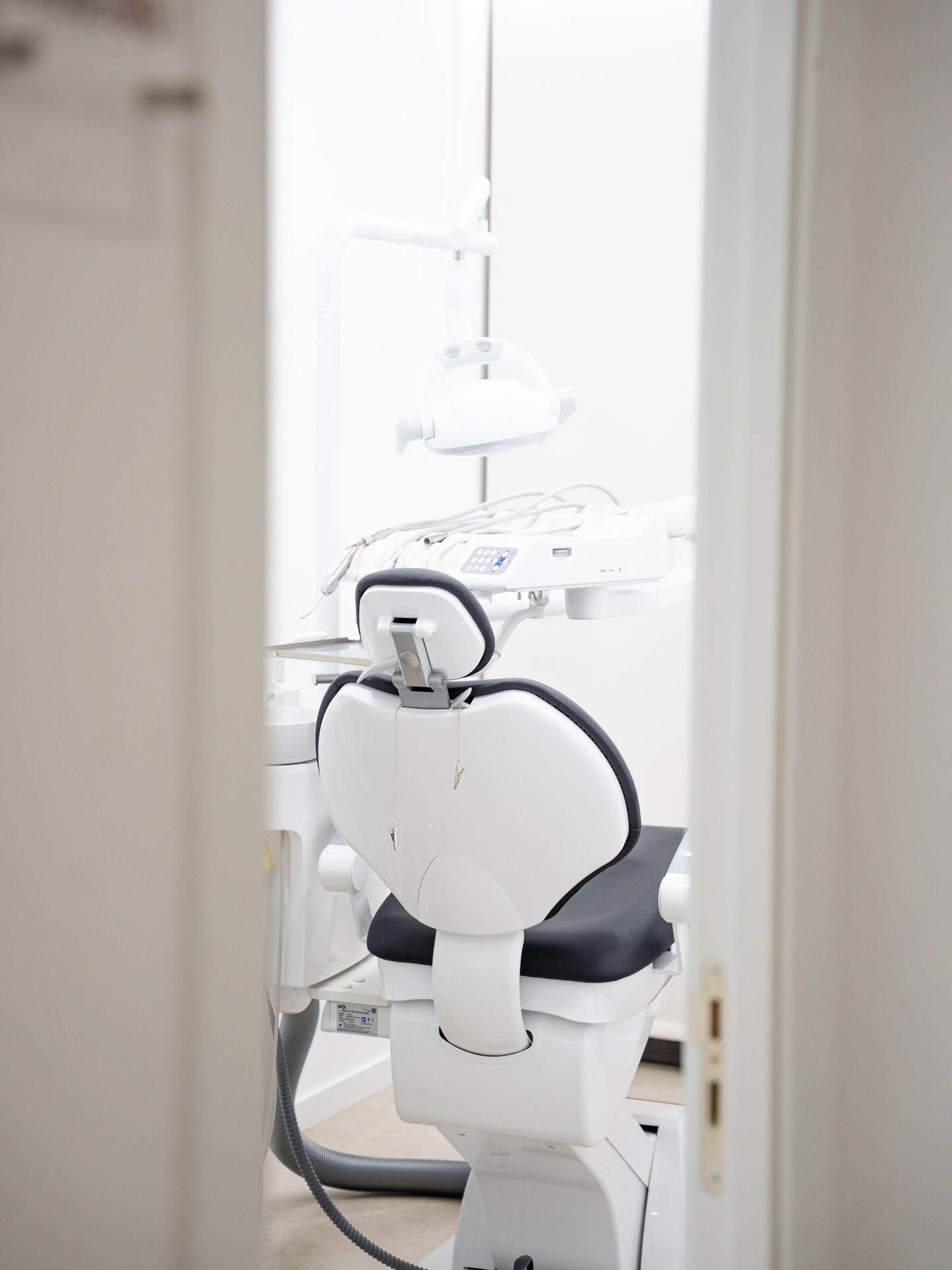 Modern dental clinic treatment room with professional dental chair and equipment.