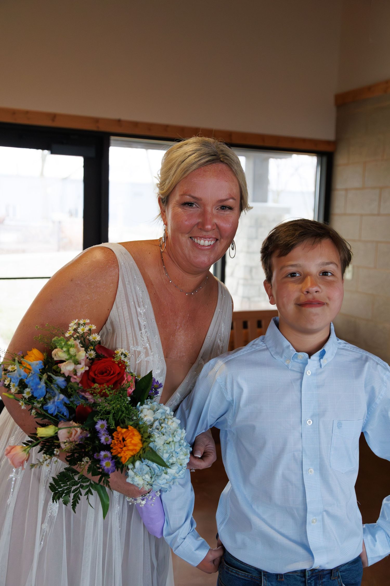 Mother and son posing for photo before wedding ceremony in wisconsin