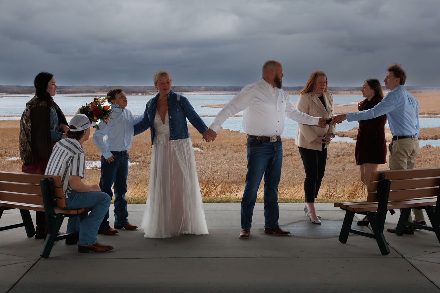 Family connecting after wedding ceremony on a stormy day in Horicon Marsh. Wisconsin Elopement