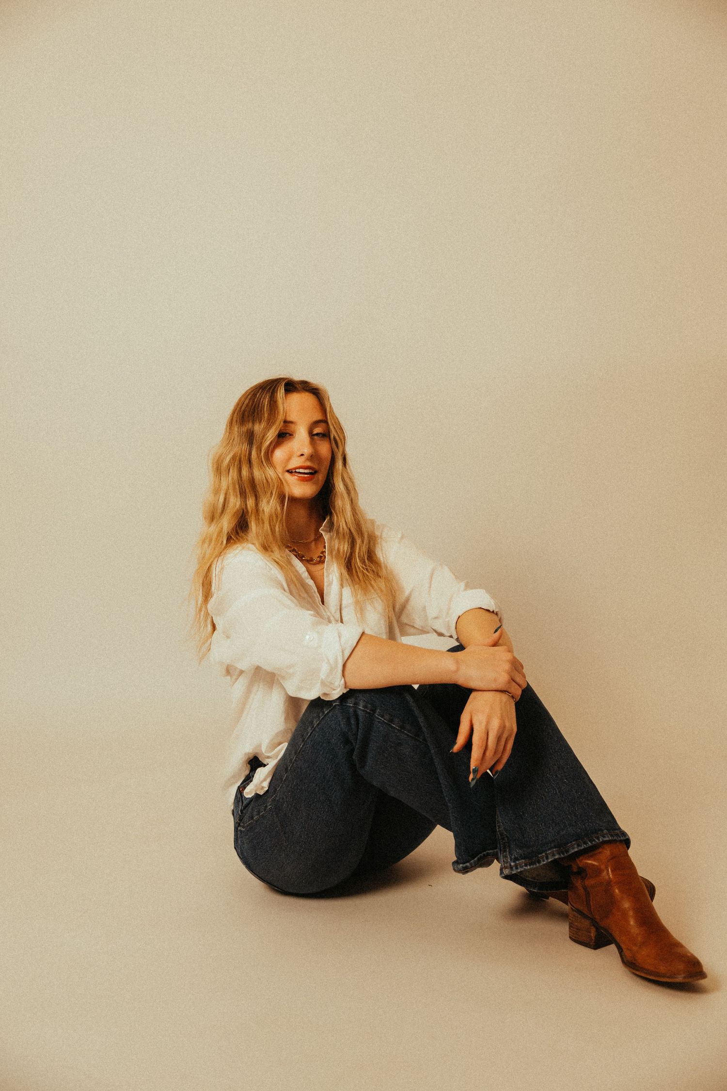 A soft studio portrait capturing a calm, confident moment.