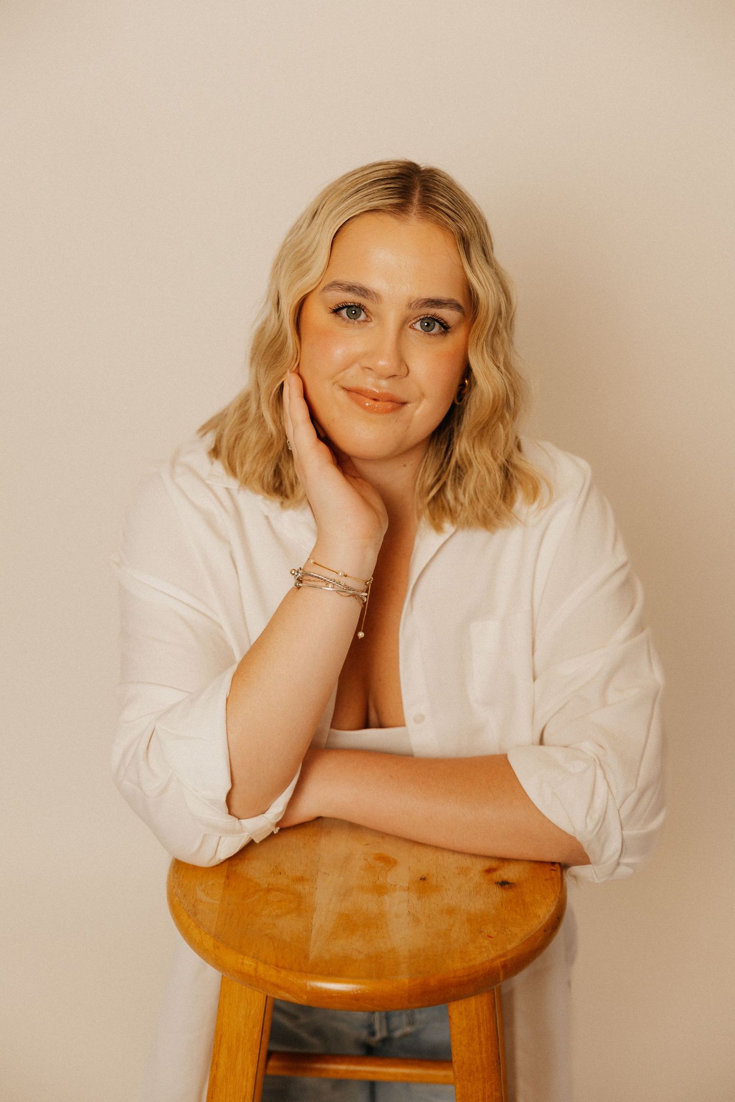 A soft studio portrait capturing a calm, confident moment.
