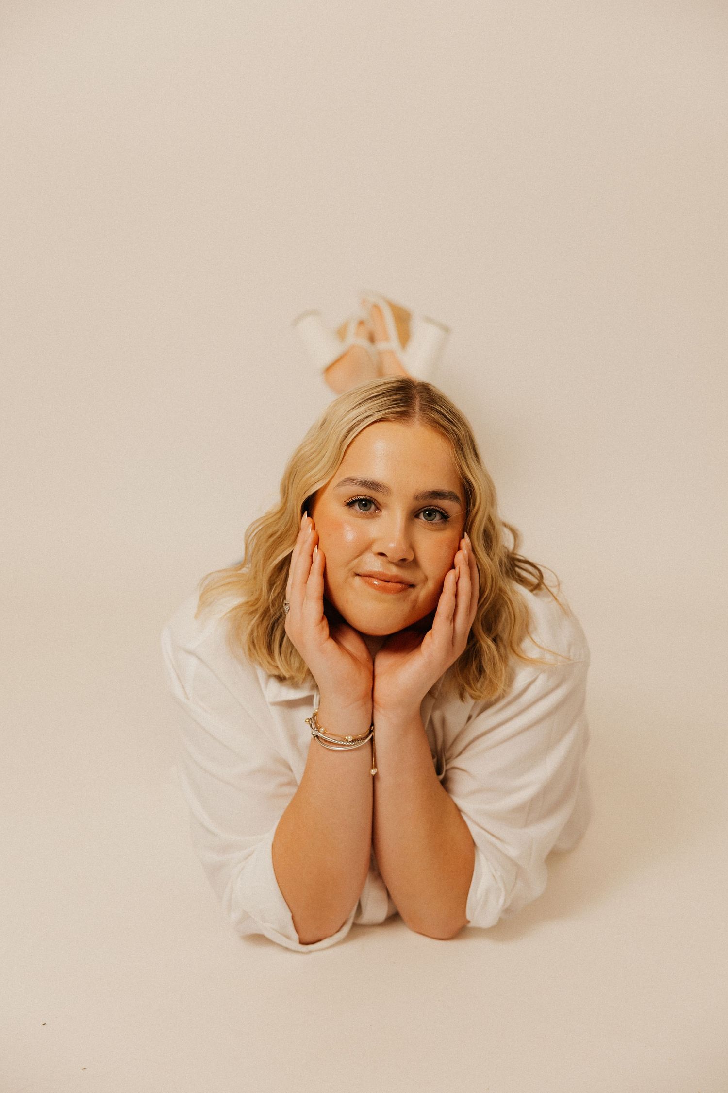 A soft studio portrait capturing a calm, confident moment.