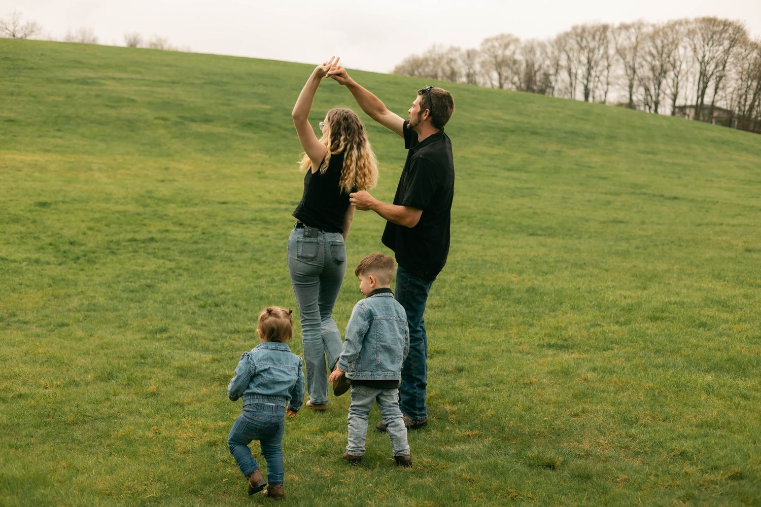A quiet moment of a family holding each other, full of warmth and connection.