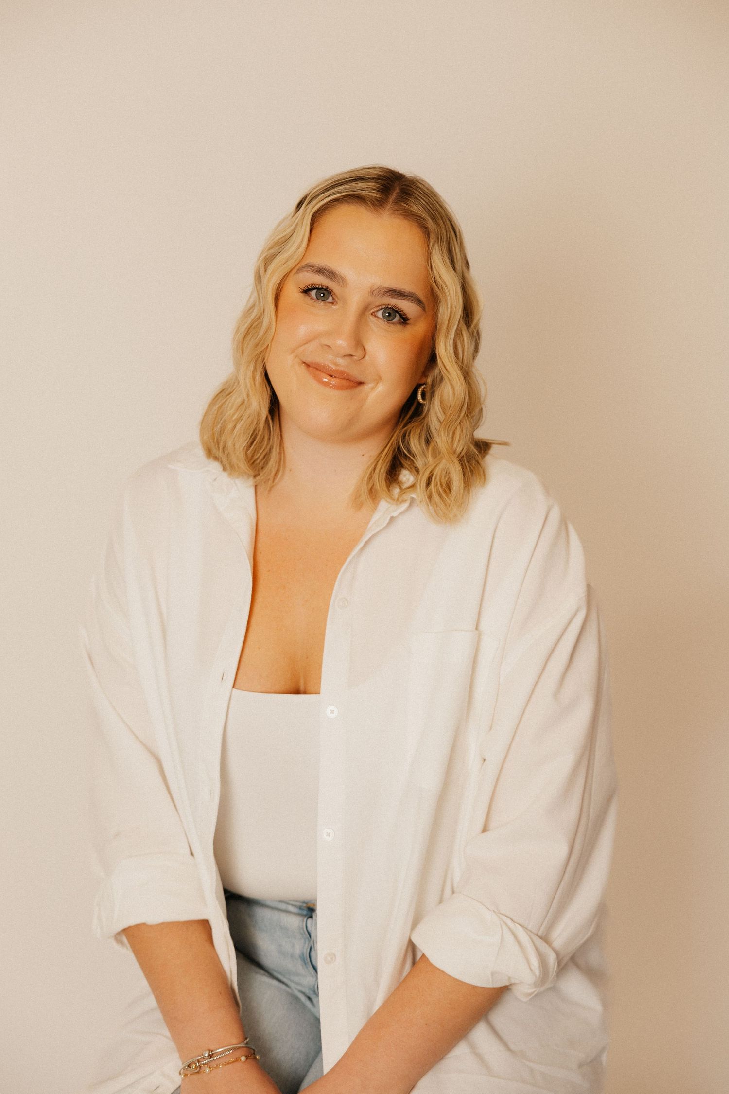 A soft studio portrait capturing a calm, confident moment.