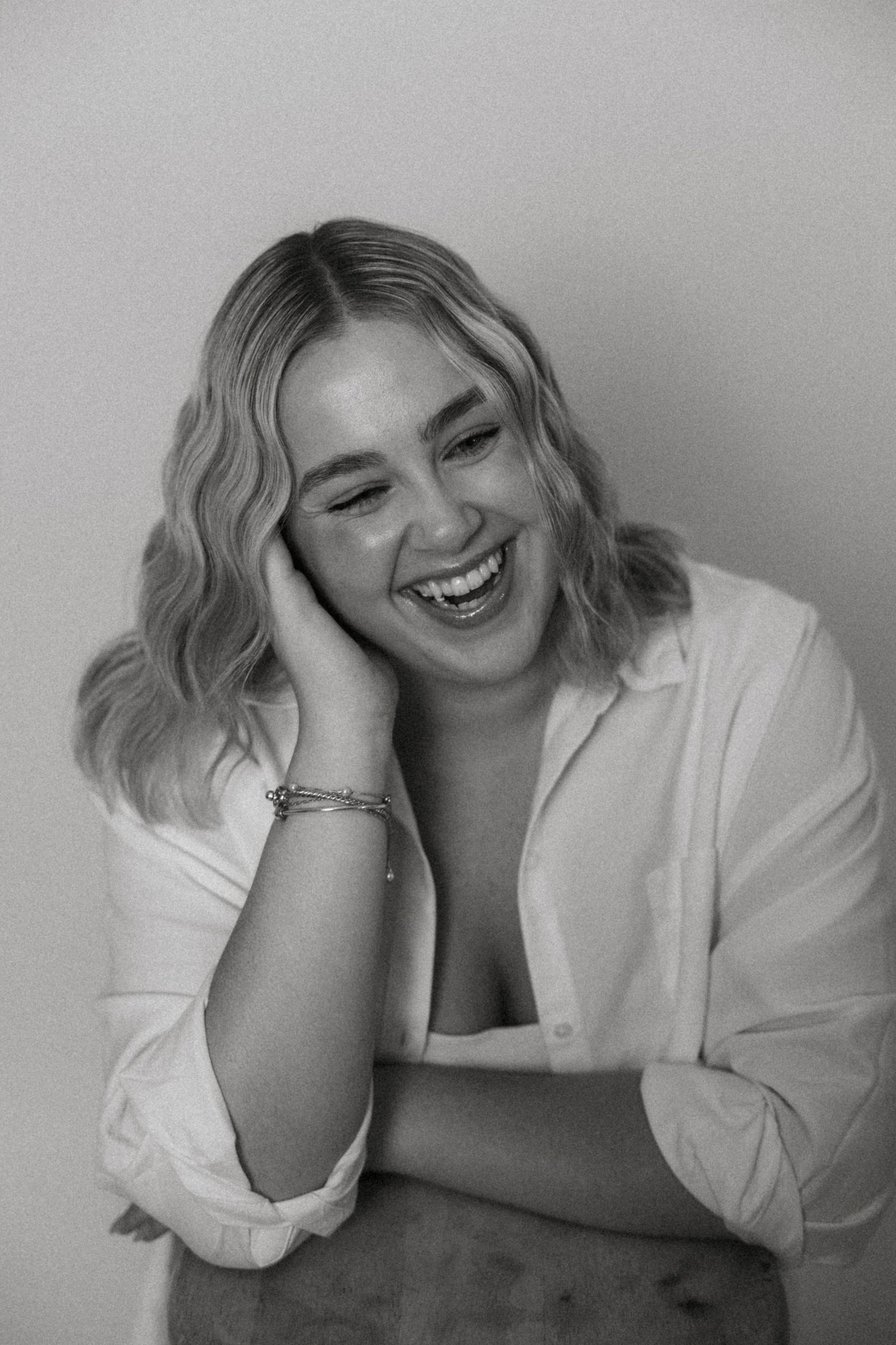 A soft studio portrait capturing a calm, confident moment.