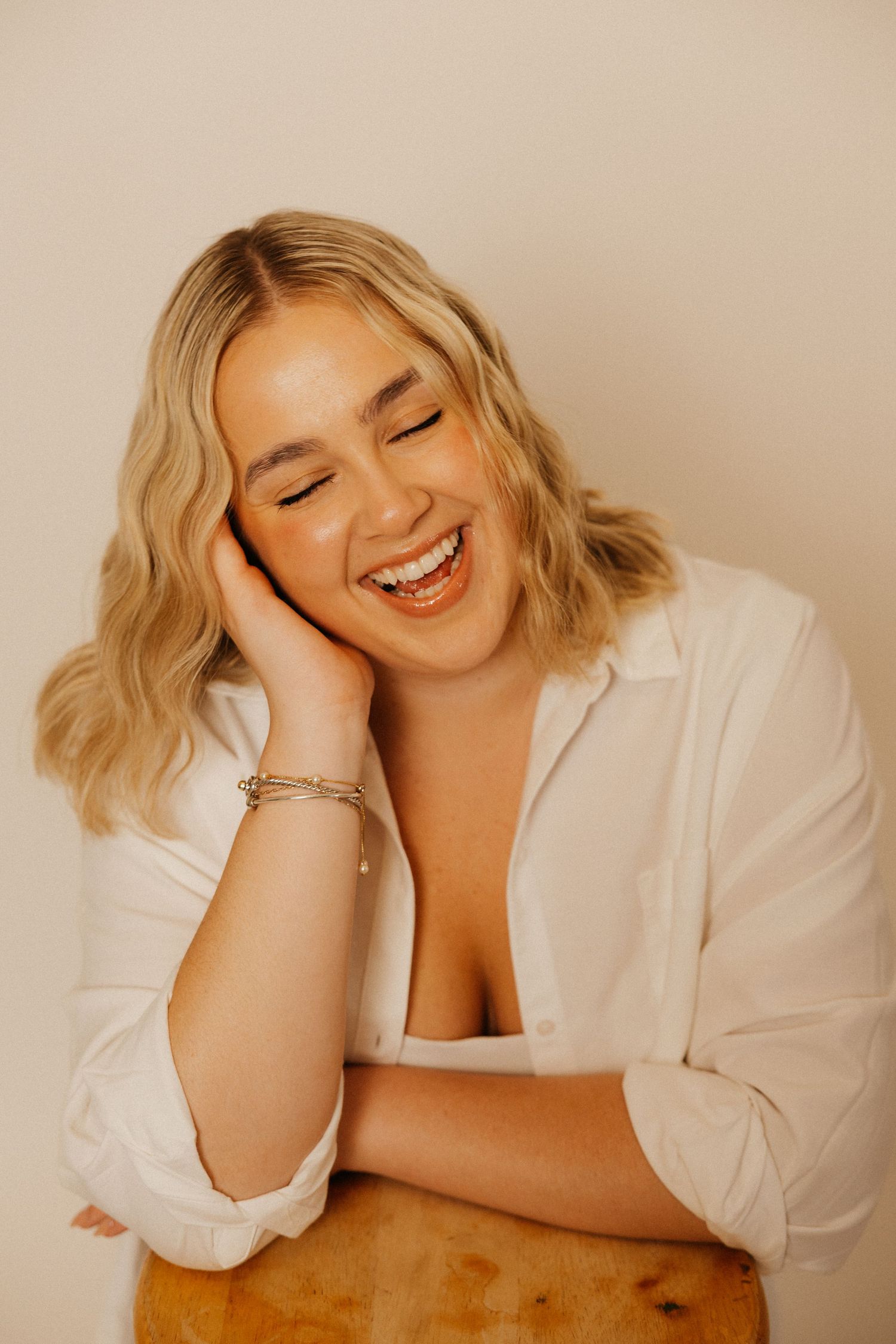 A soft studio portrait capturing a calm, confident moment.