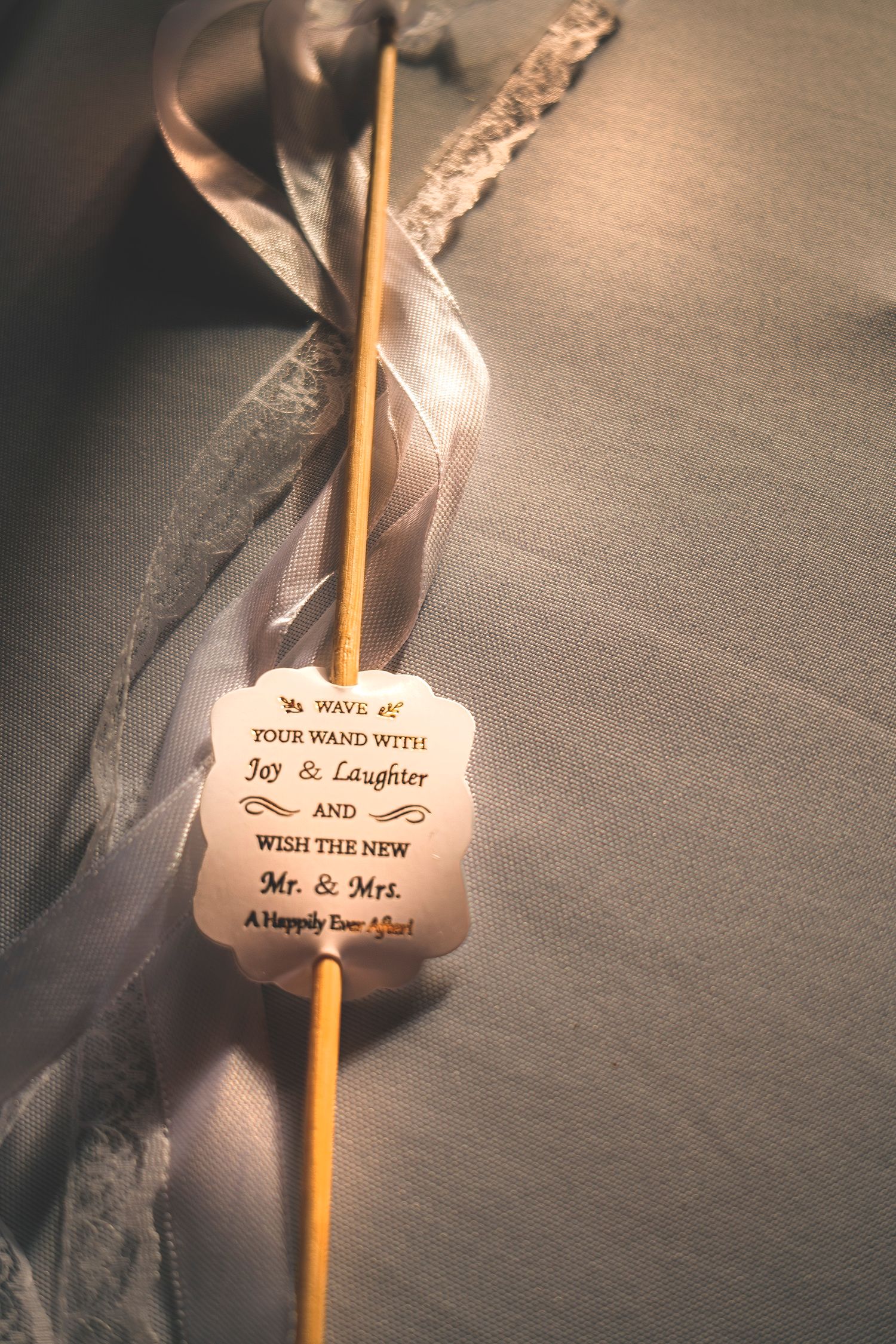 Wedding wand favor with ribbon and joy laughter Mr and Mrs message.
