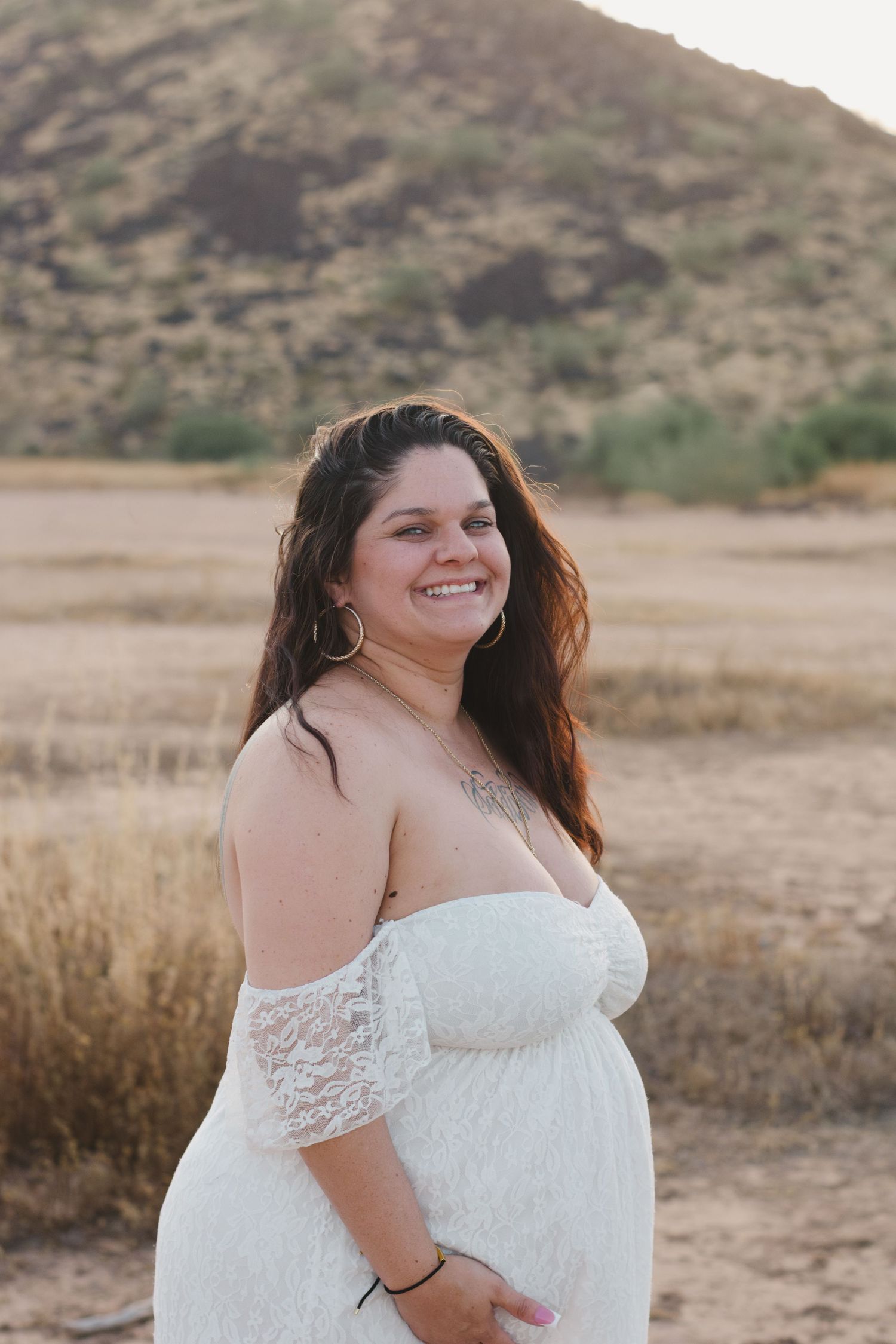 pregnancy photoshoot with mountains in the background and a beautiful white dress