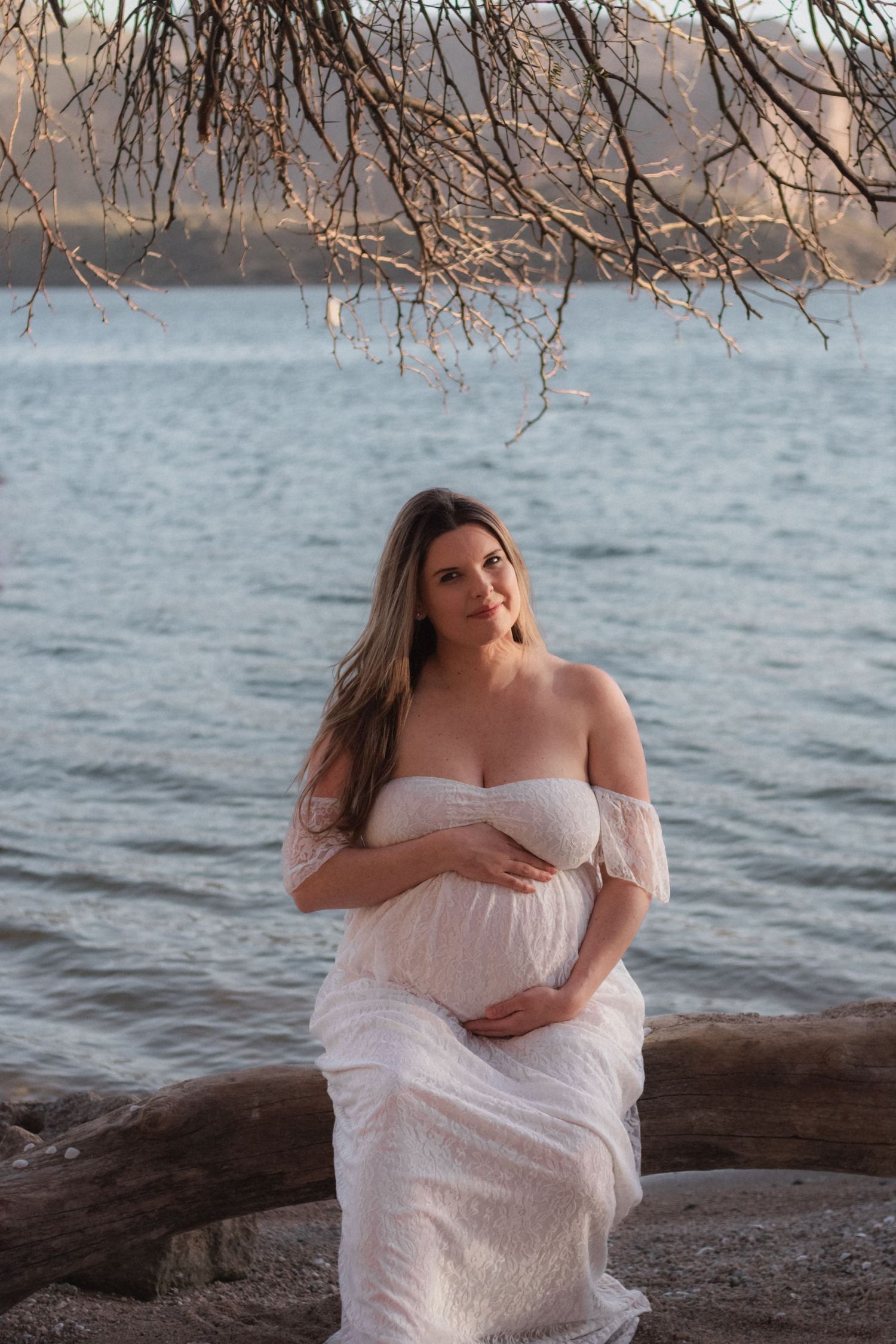 pregnancy maternity shoot. Arizona photoshoot with lake and sunset. white crown and white dress