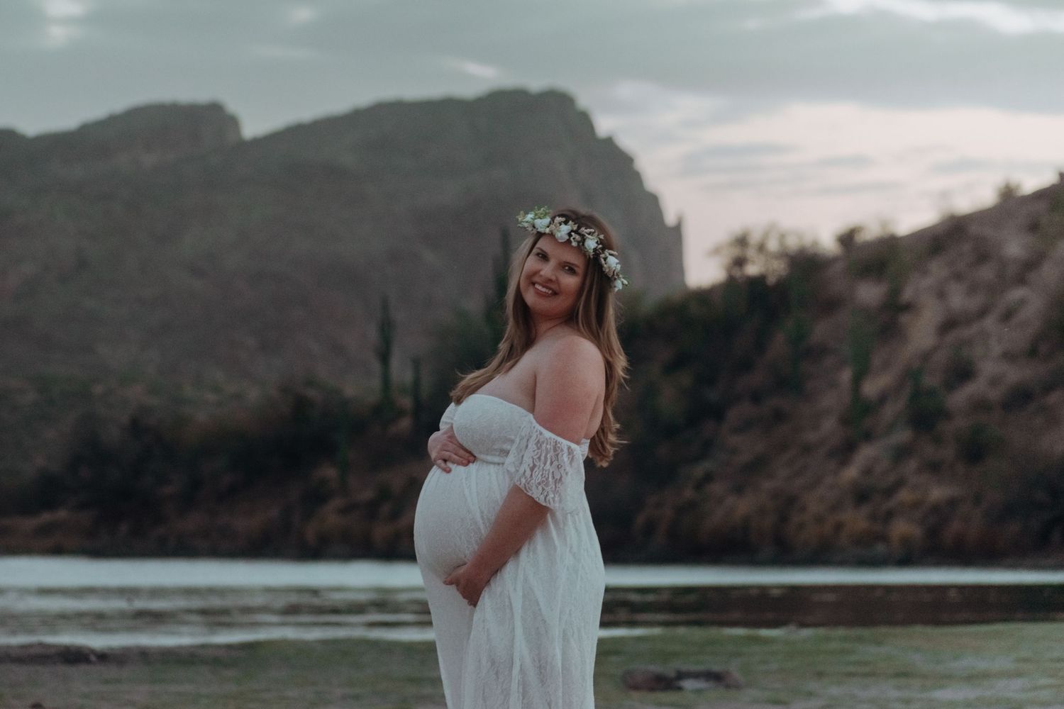 pregnancy maternity shoot. Arizona photoshoot with lake and sunset. white crown and white dress