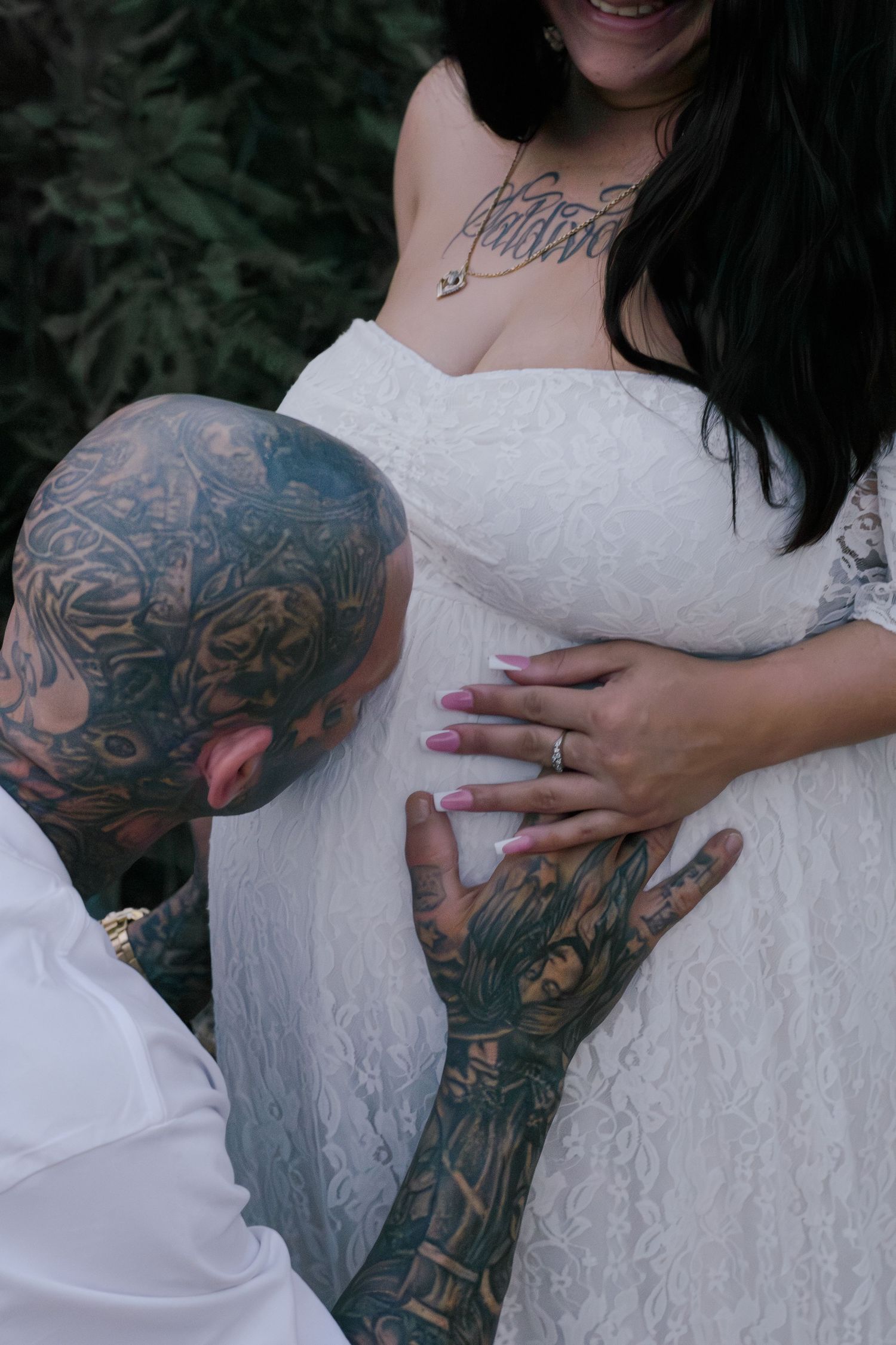 pregnancy photoshoot with arizona mountains in the background daddy kissing belly