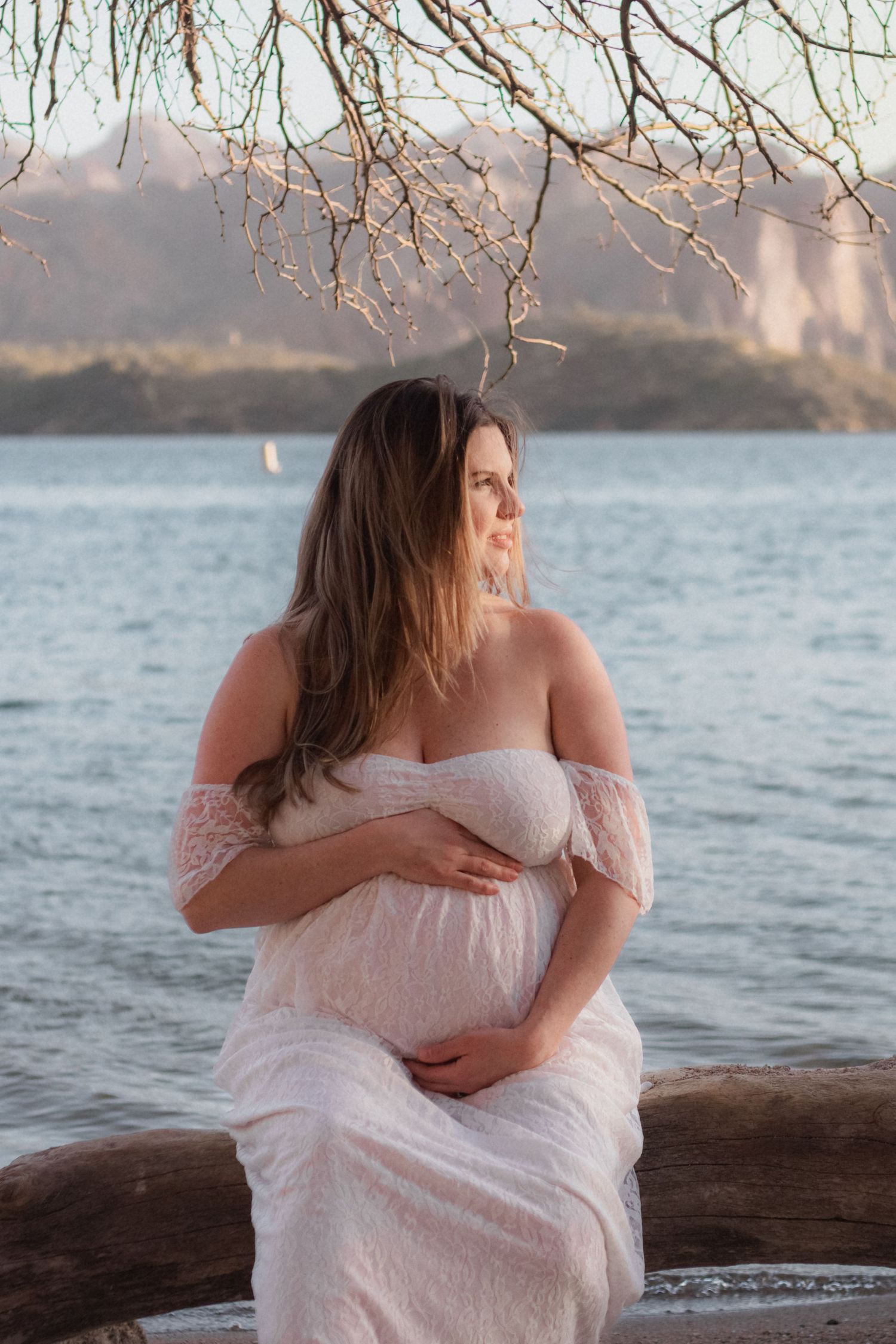 pregnancy maternity shoot. Arizona photoshoot with lake and sunset. white crown and white dress