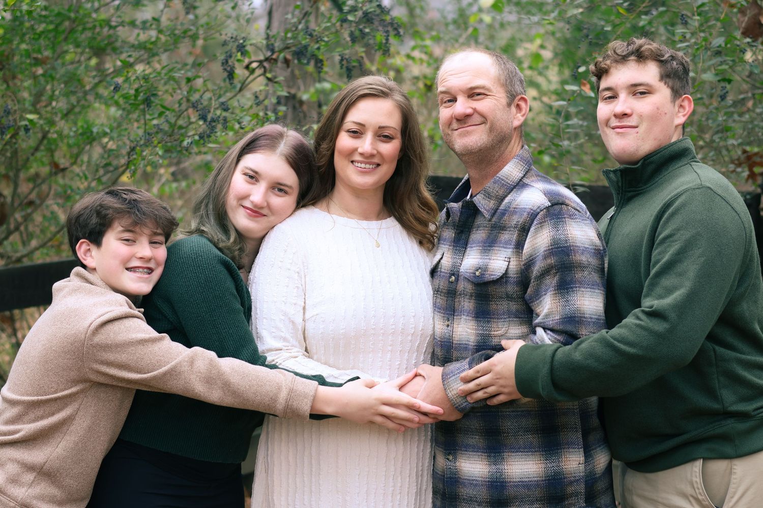 A series of five connected outdoor photos showing tender family moments against a natural backdrop.