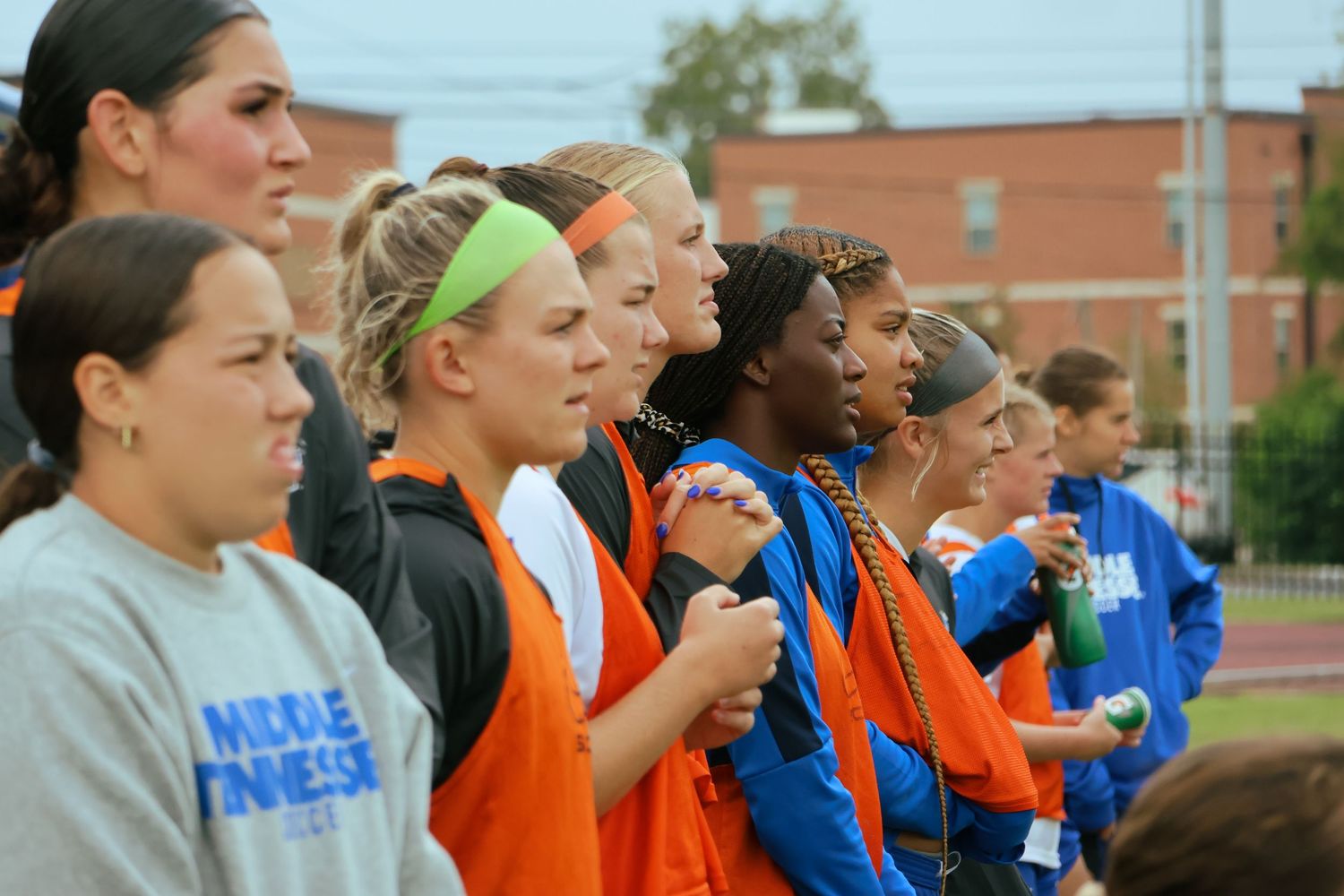Digital photograph of soccer players (female) watching on the bench.