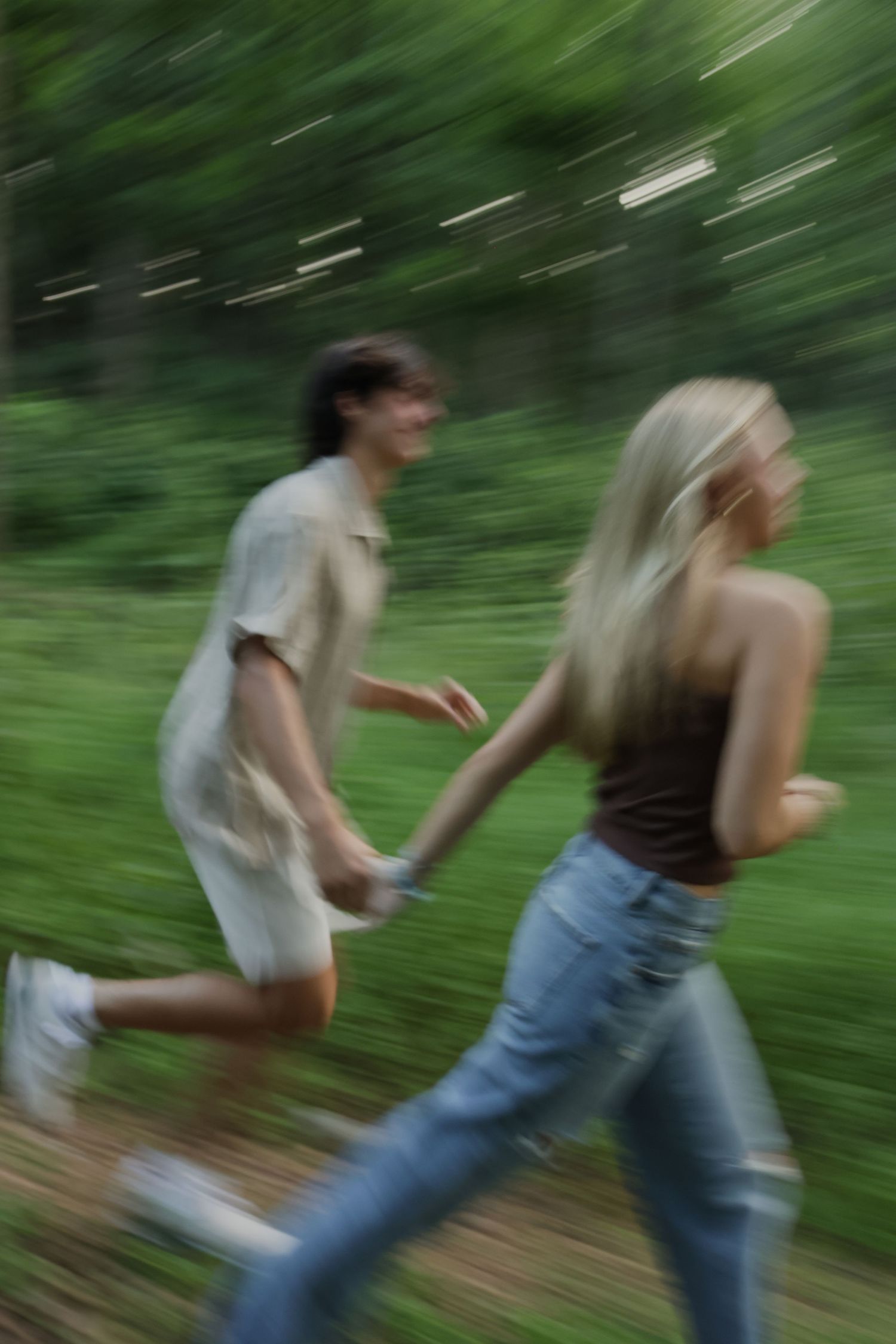 Digital photograph of a couple smiling and chasing after one another.