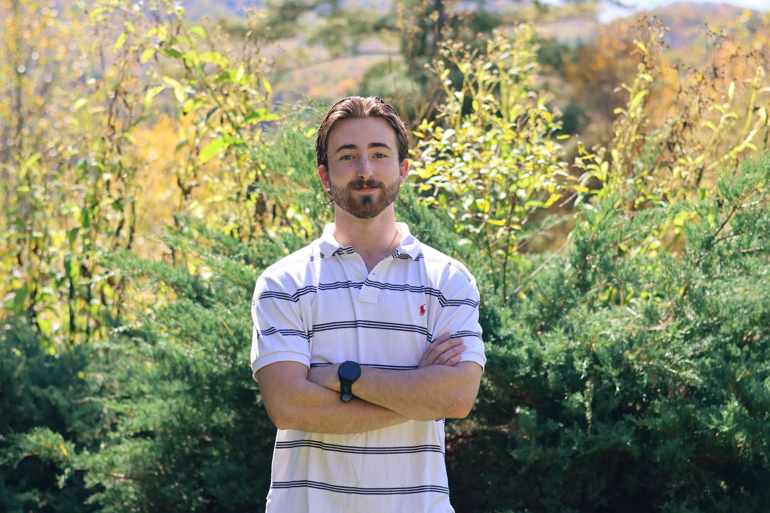 Casual outdoor portraits in natural mountain setting with golden sunlight.