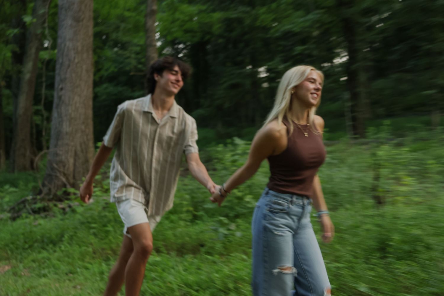 Digital photograph of a couple smiling and chasing after one another.