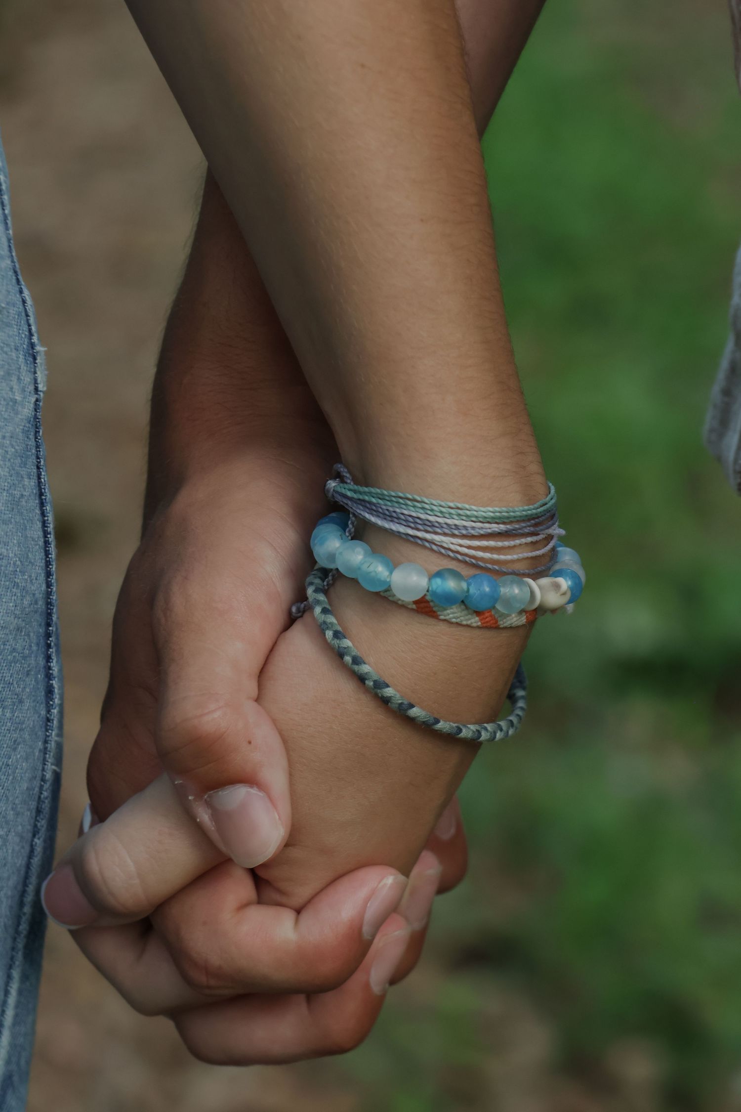 Digital photograph of a couple holding hands.
