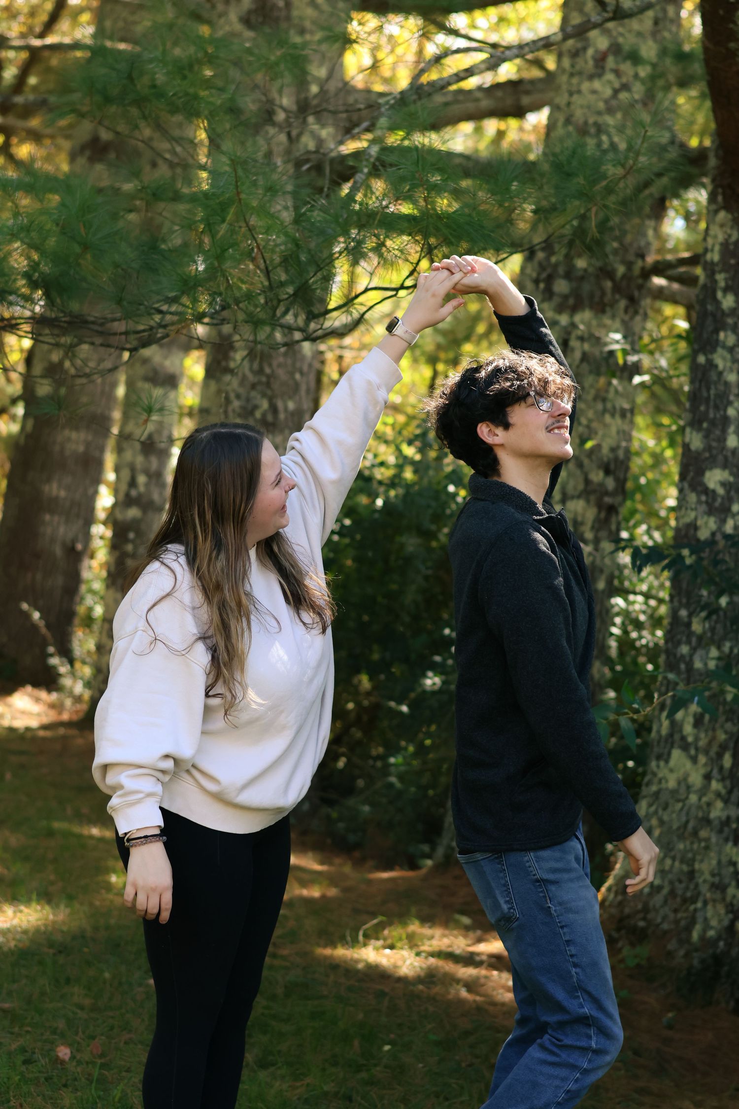 Dancing together in a forest clearing with sunlight filtering through the trees.