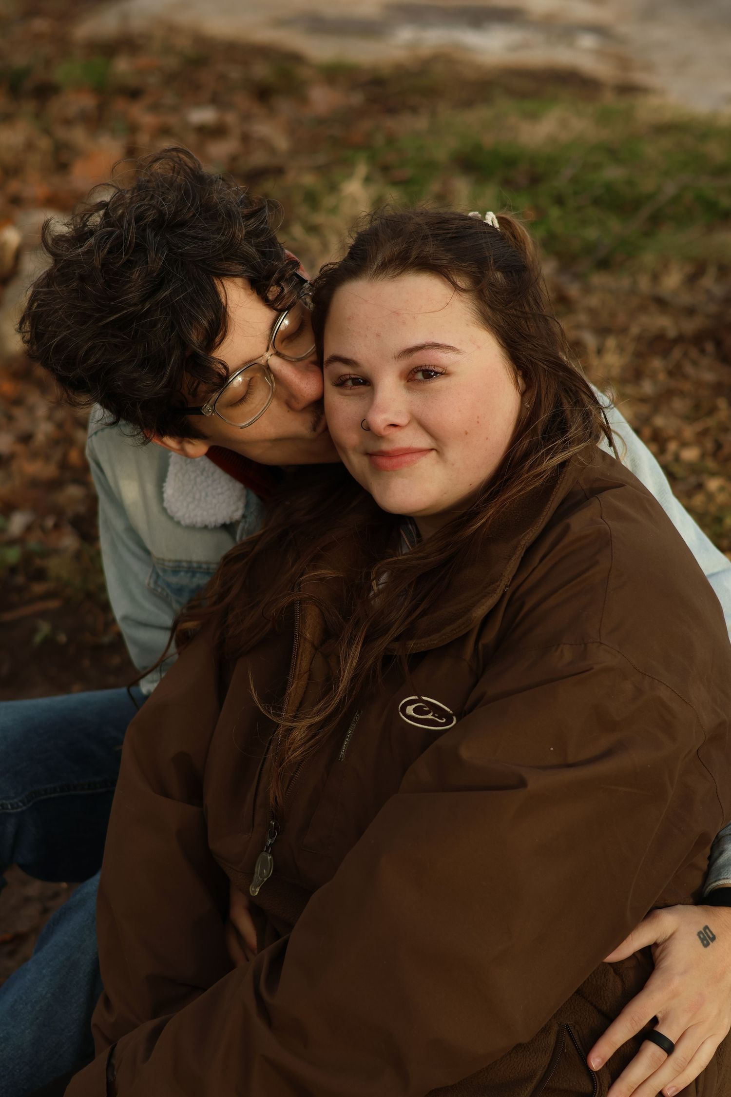 An intimate outdoor portrait of a couple sharing a close moment together on an autumn day.