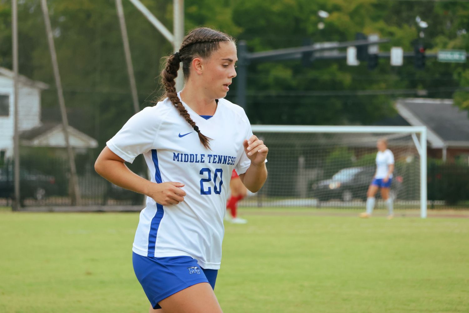 Digital photograph of a soccer player (female) jogging past.