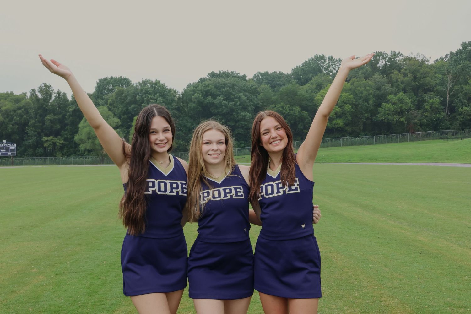 Digital photograph of 3 cheerleaders.