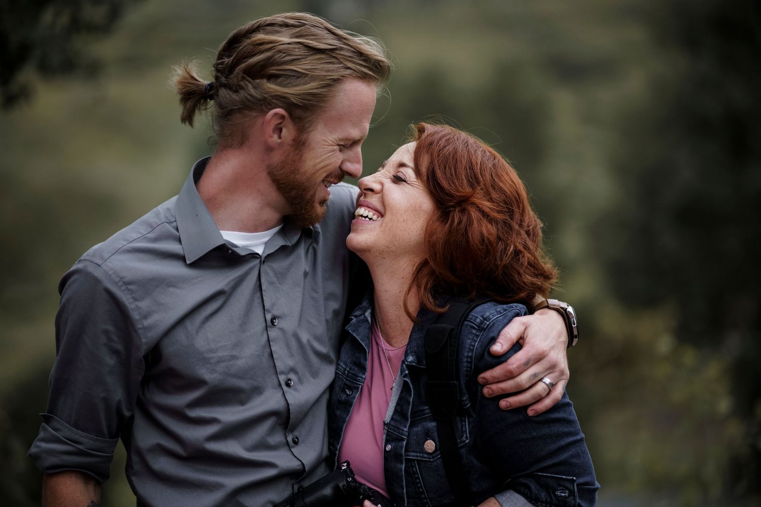 Intimate outdoor portrait of a couple sharing a close moment together.