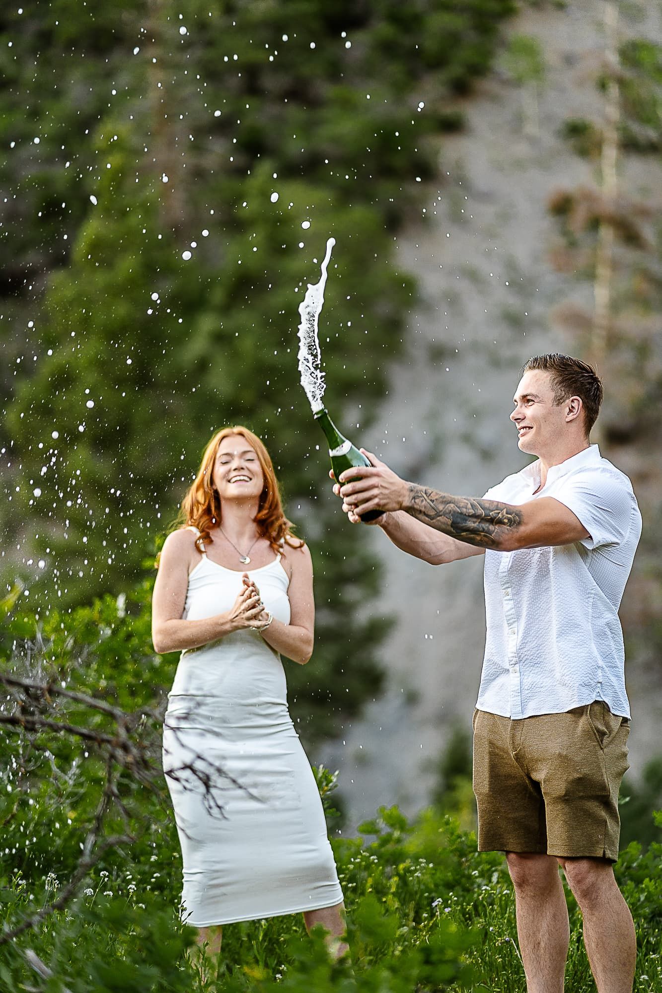 Celebratory moment with champagne spray in an outdoor nature setting. Photographer in Ouray Colorado took this photo.
