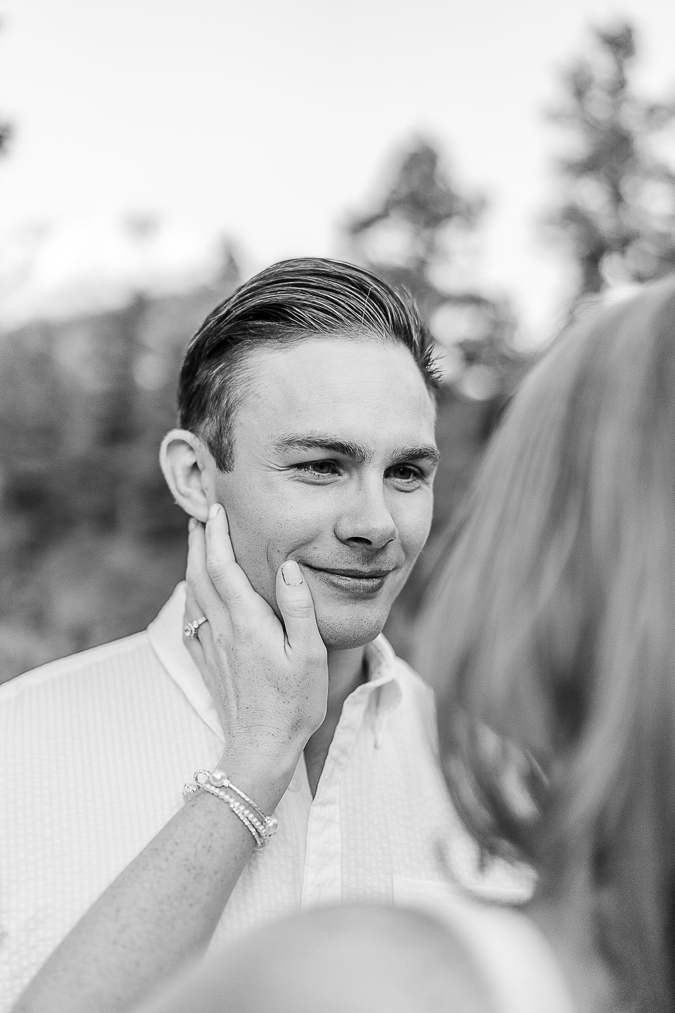 Black and white portrait showing a tender moment outdoors.
