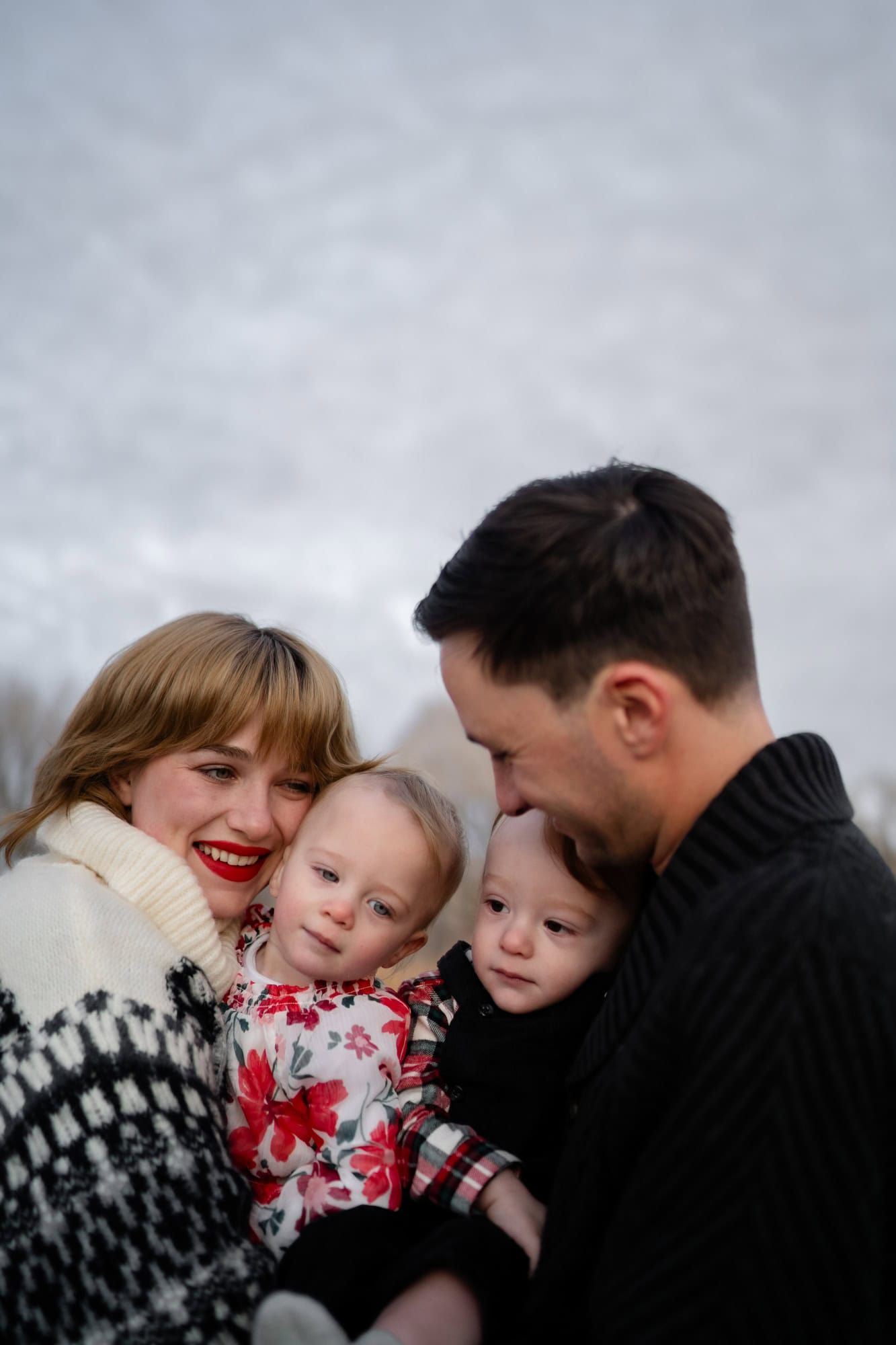 An intimate family portrait showcases warm smiles and tender embraces.
