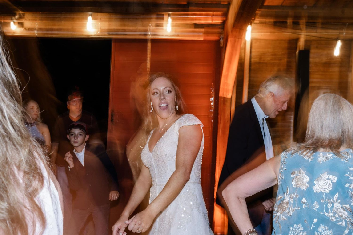 Wedding guests dancing and celebrating inside the best rustic barn venue near montrose
