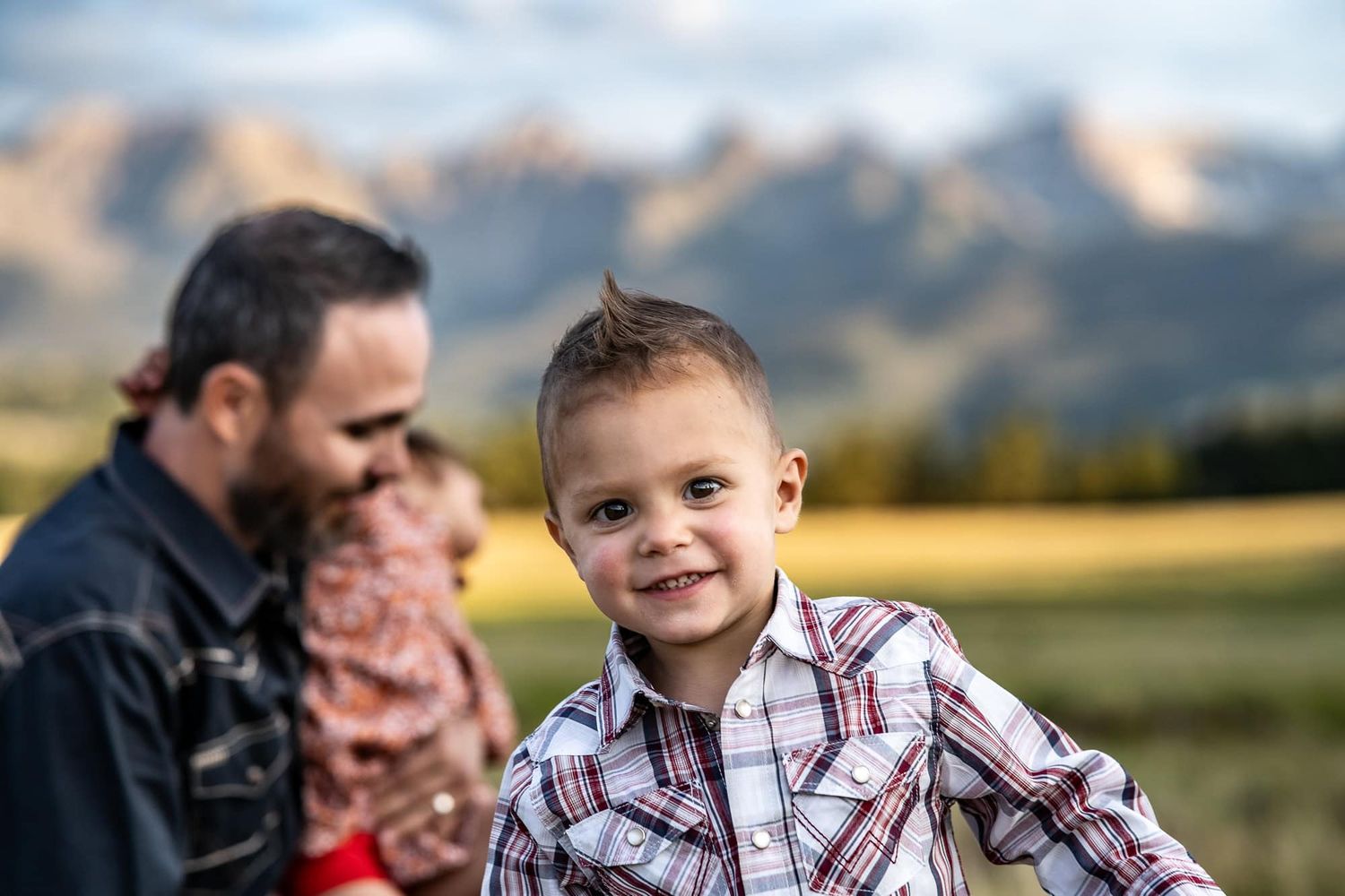 Family enjoying outdoor time together with mountains in background.