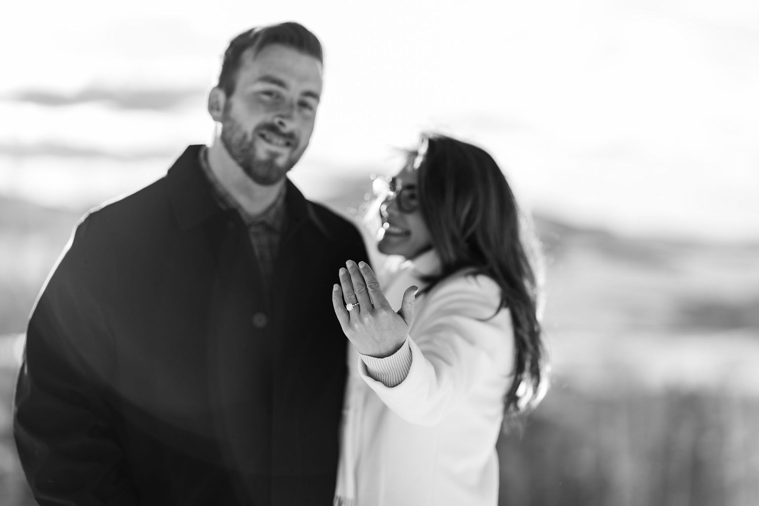 A couple shares an intimate black and white moment during their engagement session.