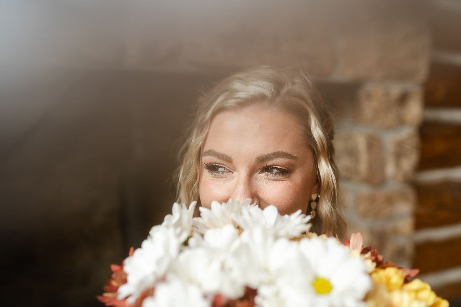 Bridal portrait with white daisies and flowers creating a dreamy atmosphere.