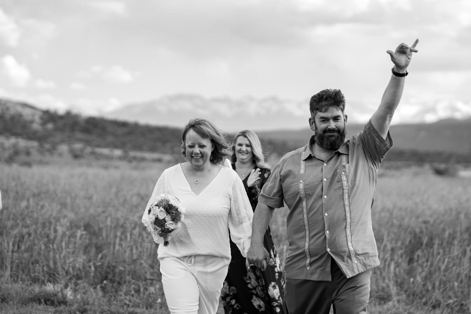 Black and white moment of bride and groom with mountain landscape. Taken at epic mountain view wedding venue near Montrose Colorado.
