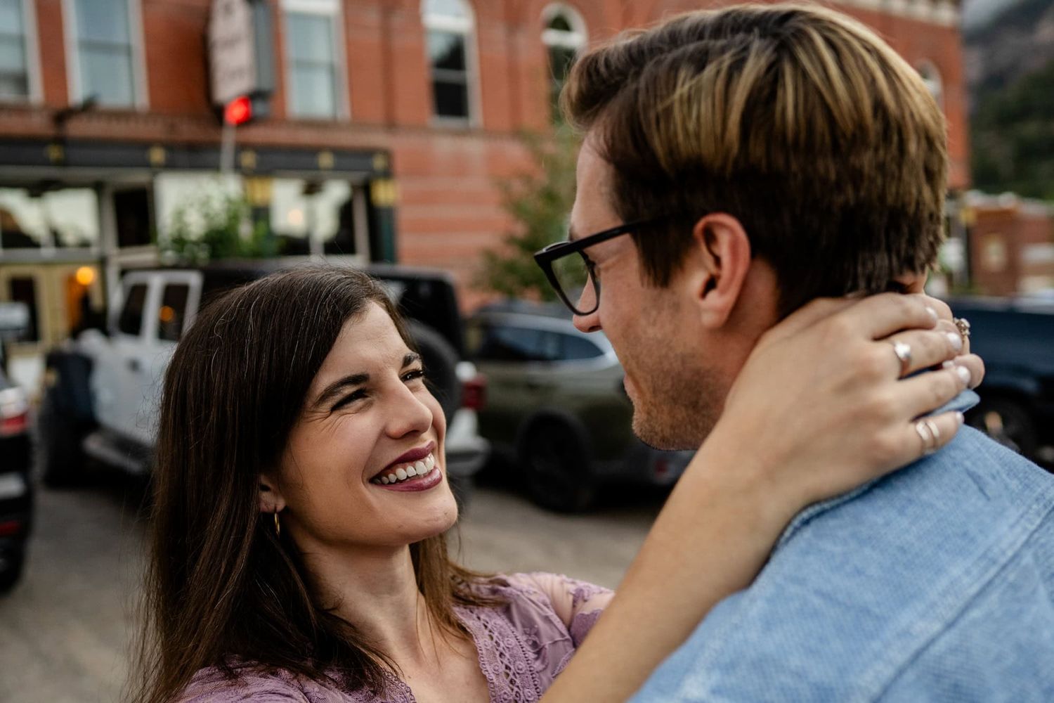 A joyful couple sharing an intimate moment on a city street.