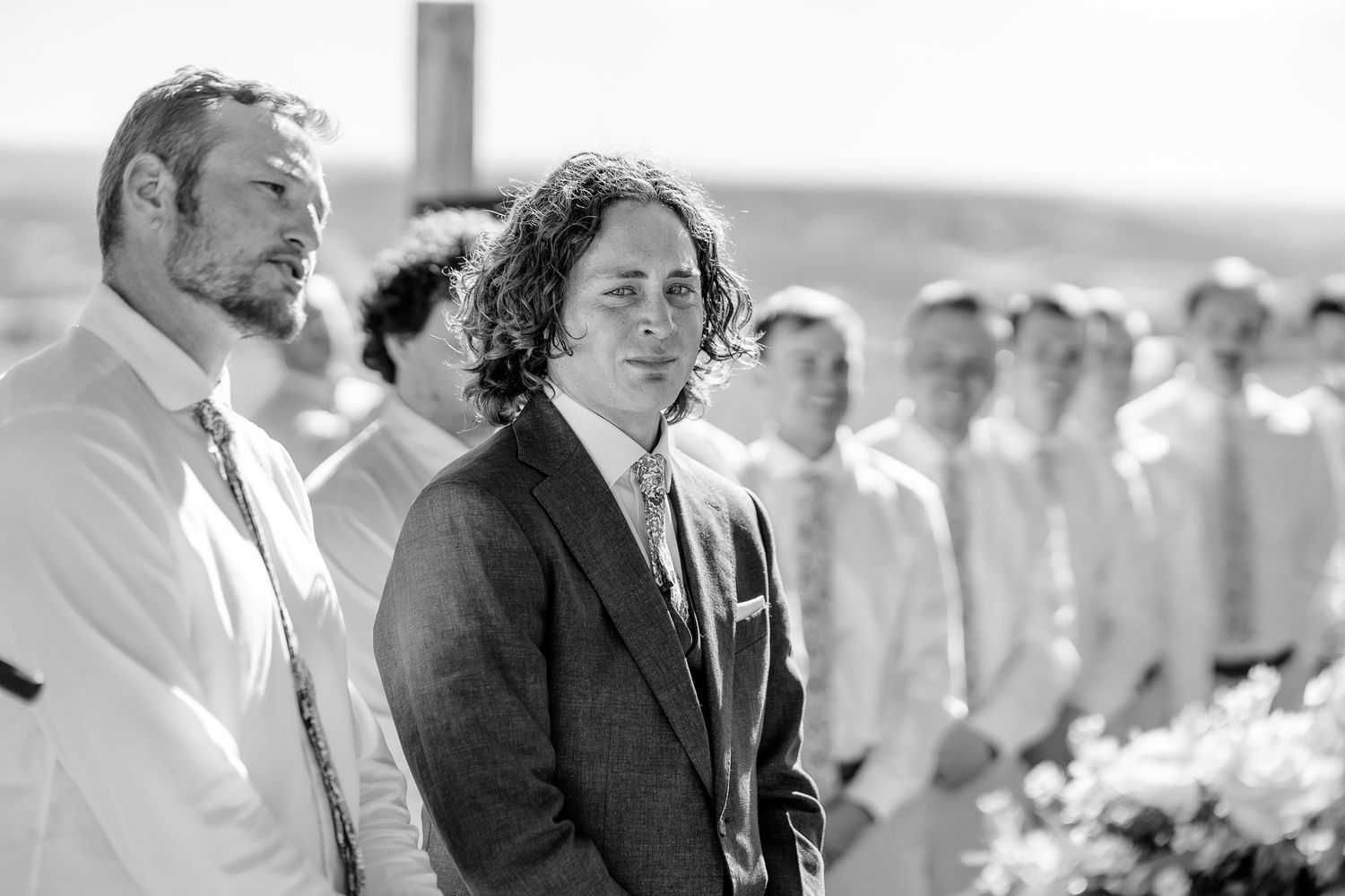 Groom is emotional in black and white photo captured at Storm King Mountain Ranch. Captured by Montrose Colorado Wedding Photographers