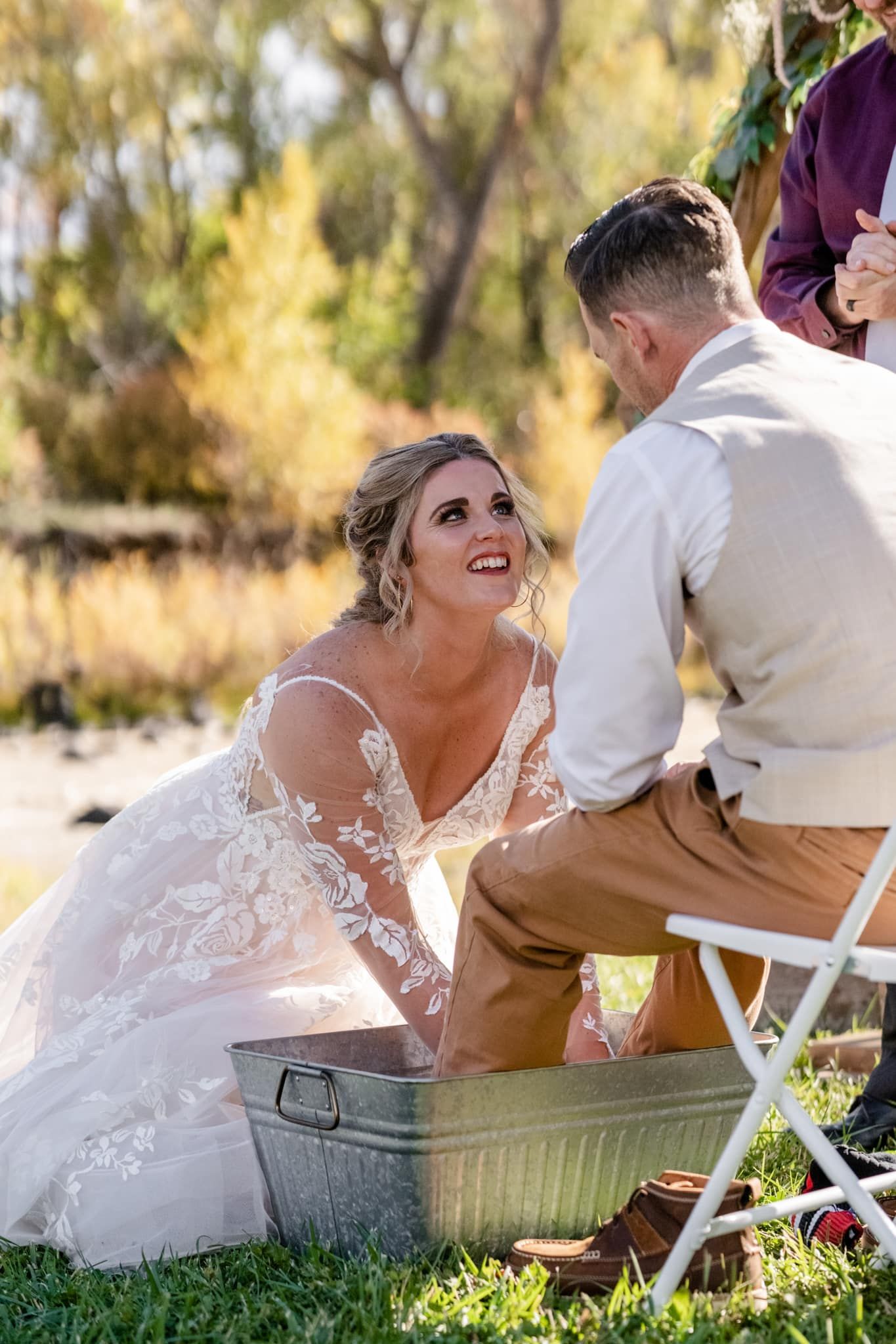 Joyful wedding moment during rustic outdoor countryside ceremony.