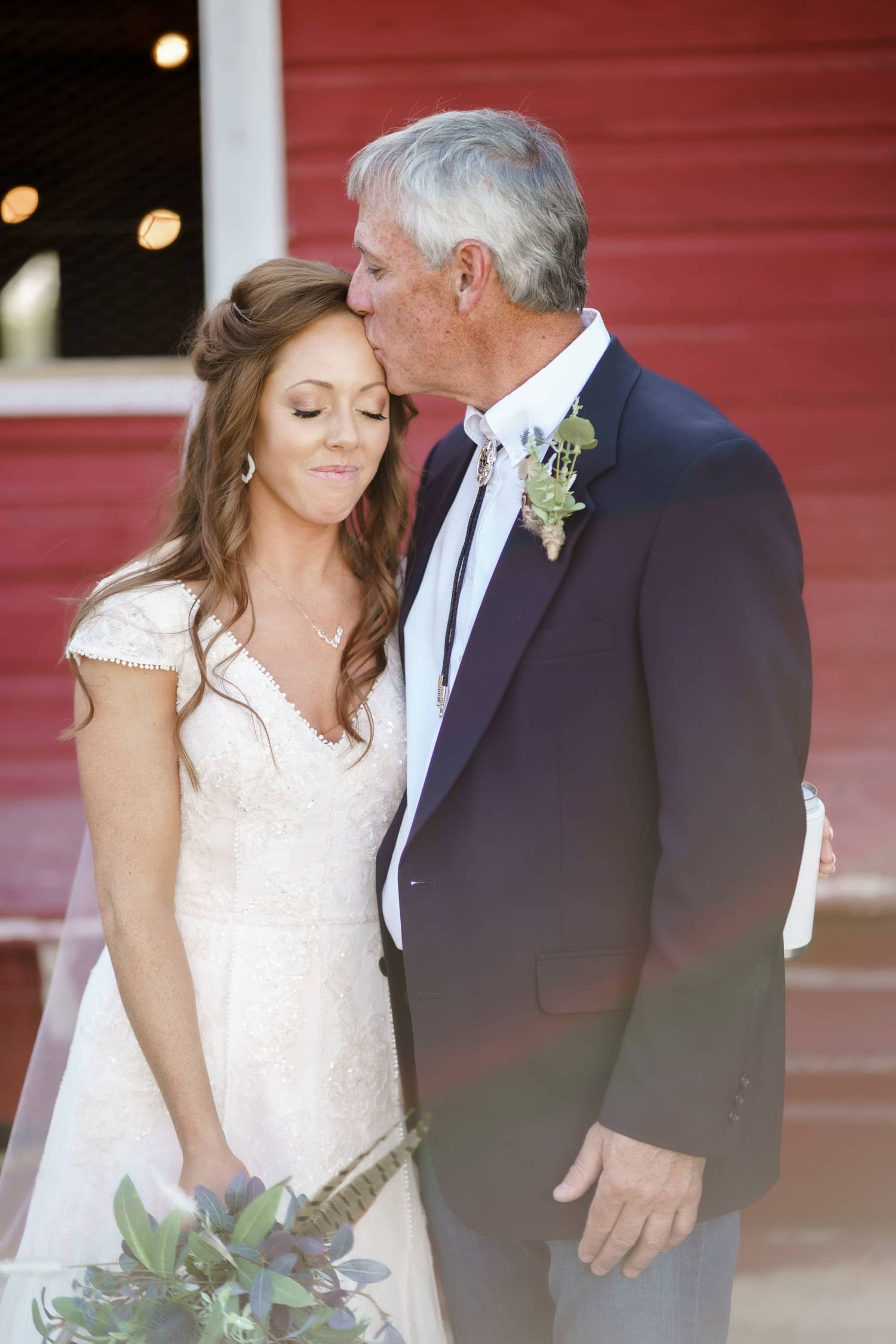 Tender moment between a bride and father at the best rustic barn venue near montrose