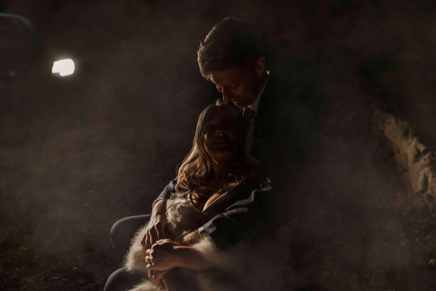 Atmospheric moody portrait in dark lighting with ethereal smoke effects.