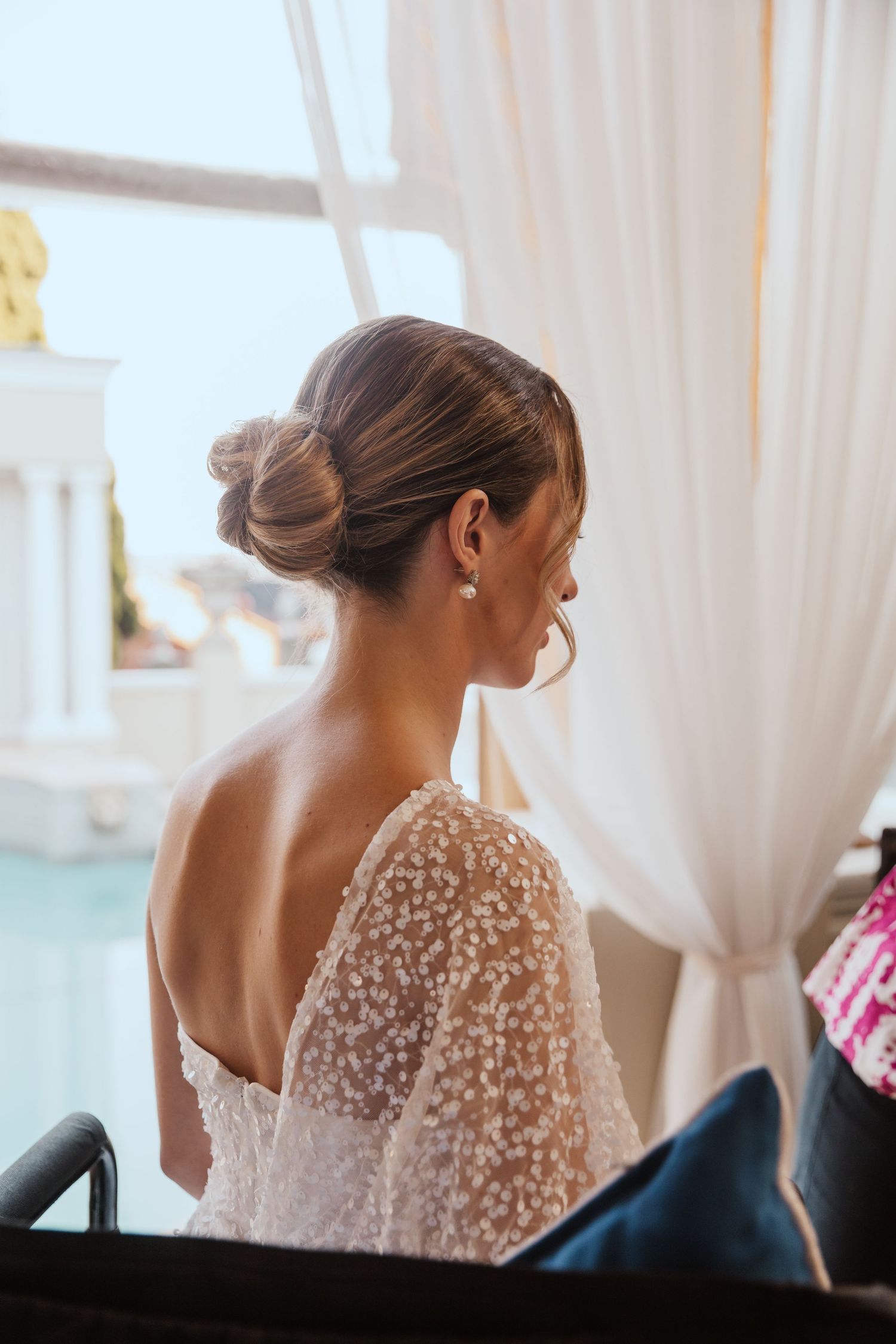 Back view of a beaded wedding dress with elegant updo hairstyle.