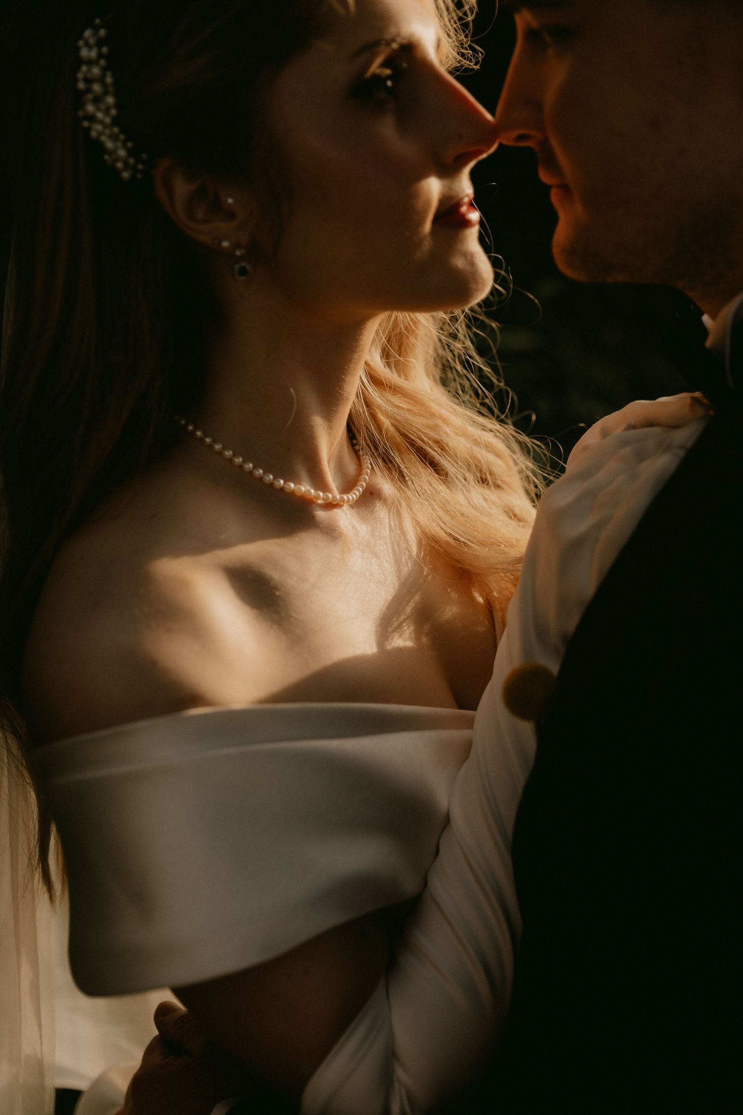 Artistic series of close-up bridal portraits showing elegant off-shoulder dress and pearl necklace in moody lighting.