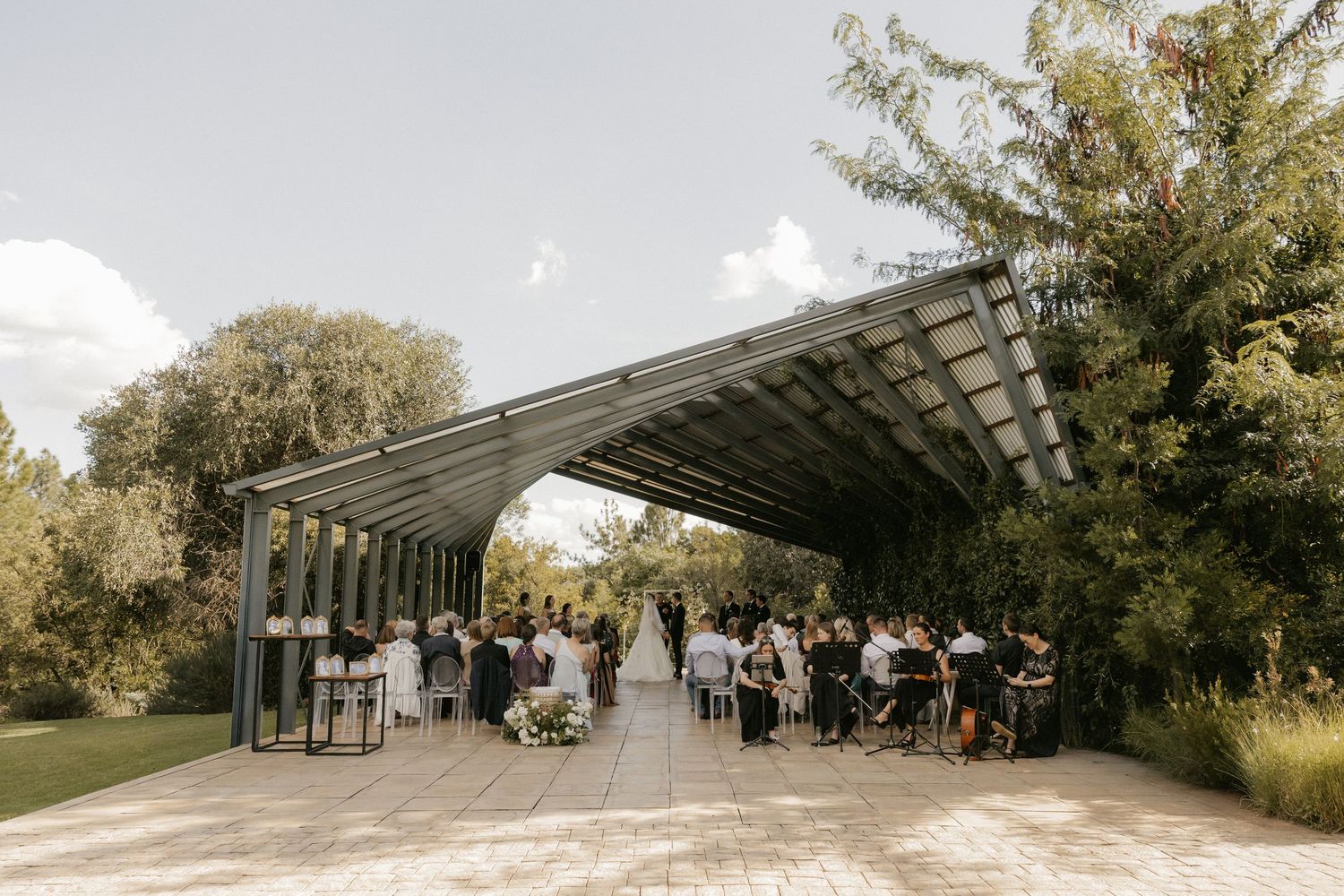 A panoramic collage of an outdoor wedding ceremony venue with white chairs and natural greenery surroundings.