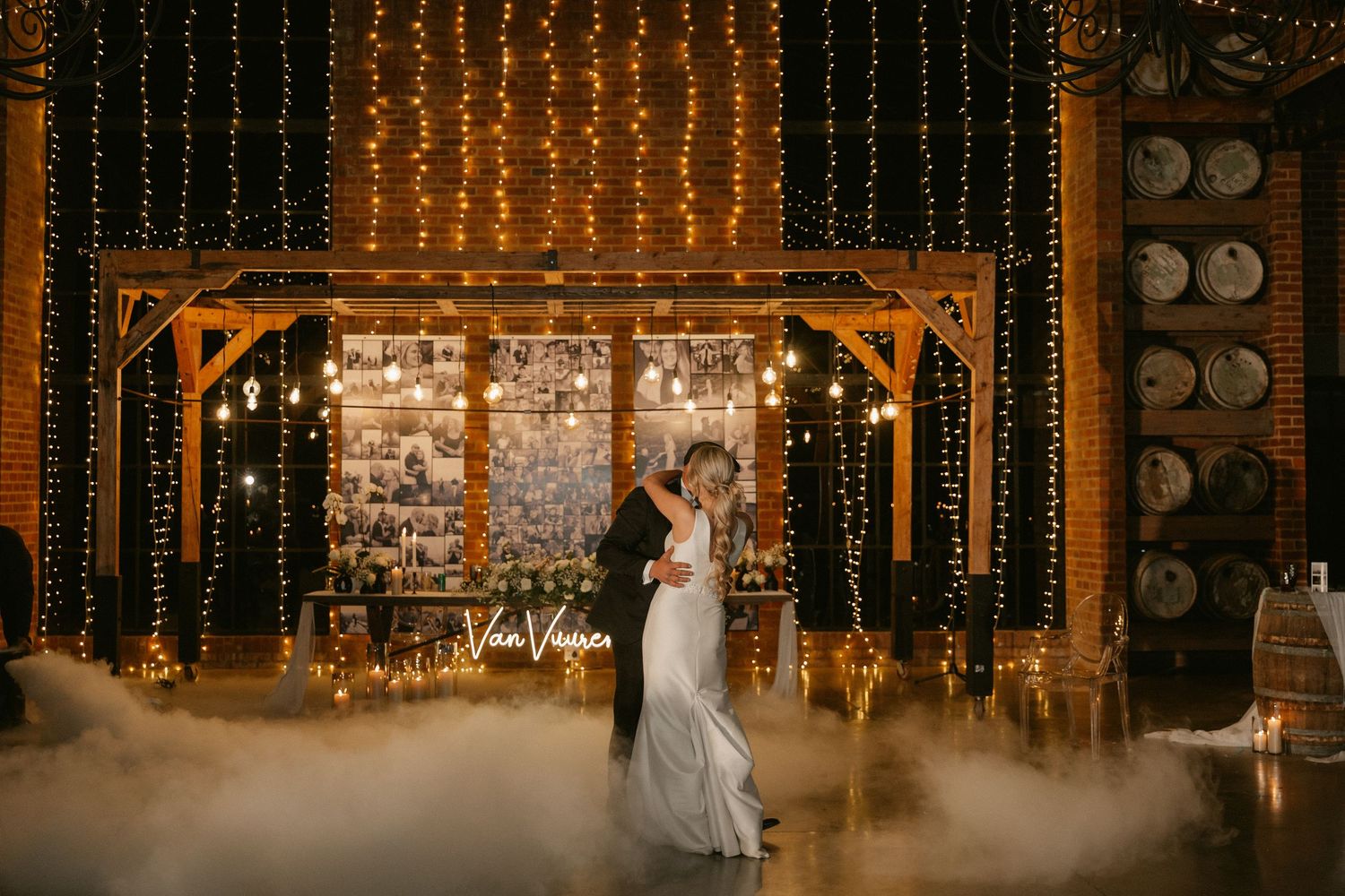 String lights and brick walls create a warm ambiance in a rustic wedding reception venue setting.