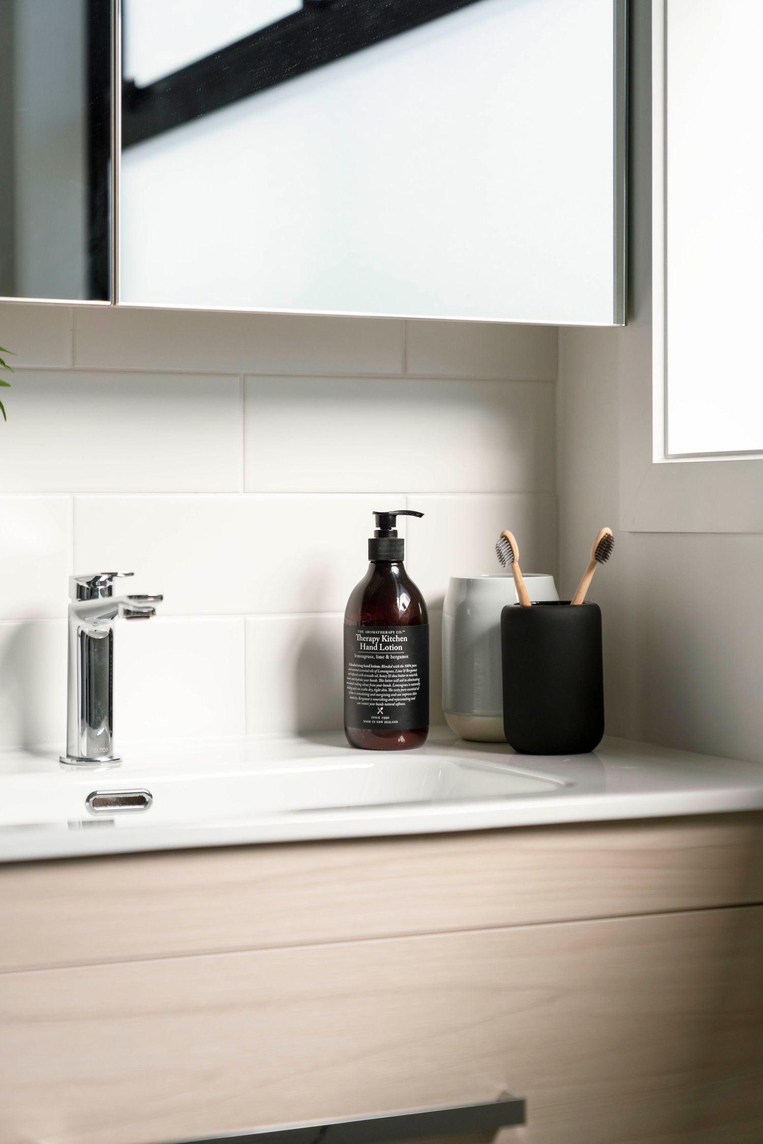 Sleek bathroom counter with minimalist soap dispensers and modern fixtures.