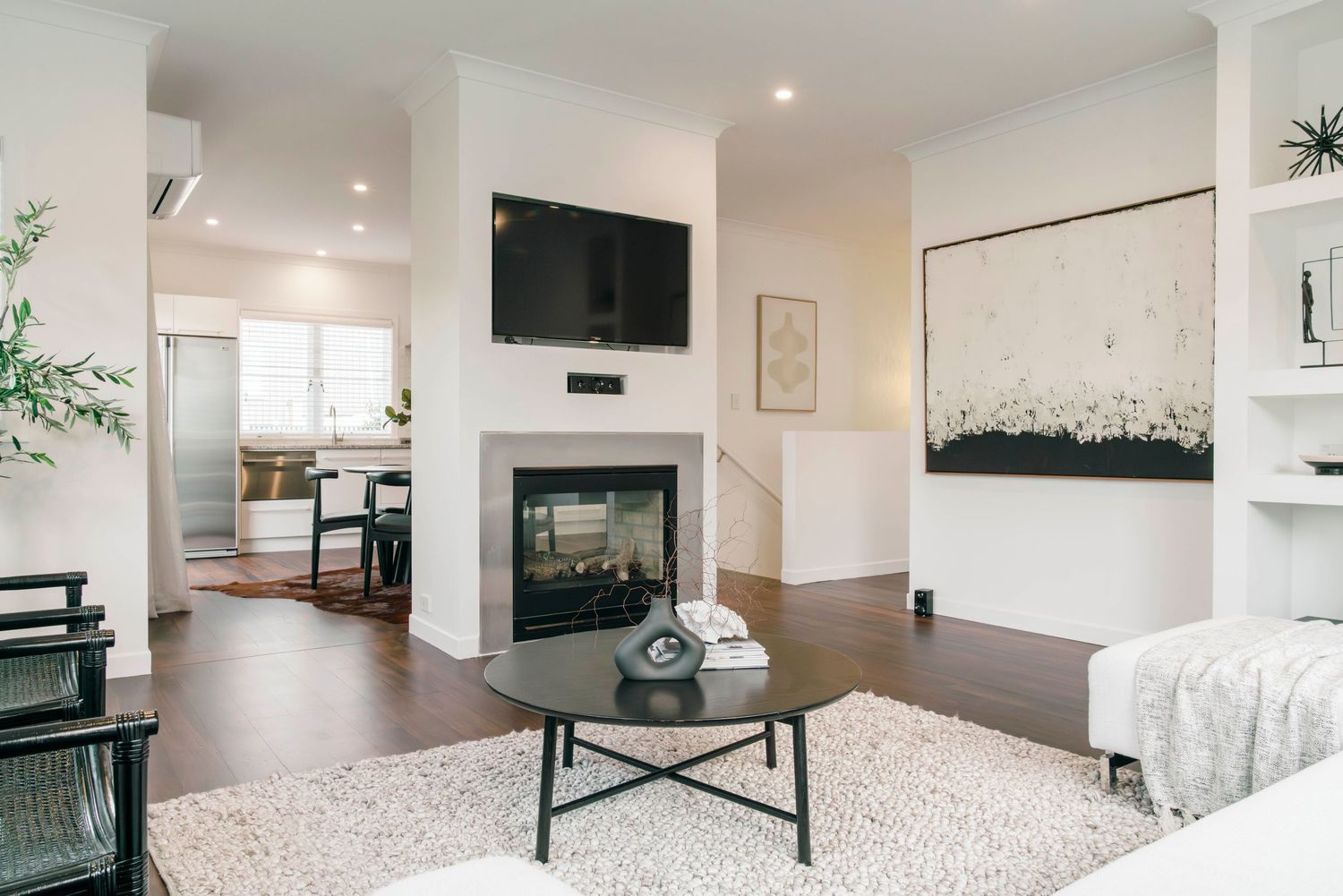 Open concept living space featuring modern furniture, recessed lighting, and hardwood floors.
