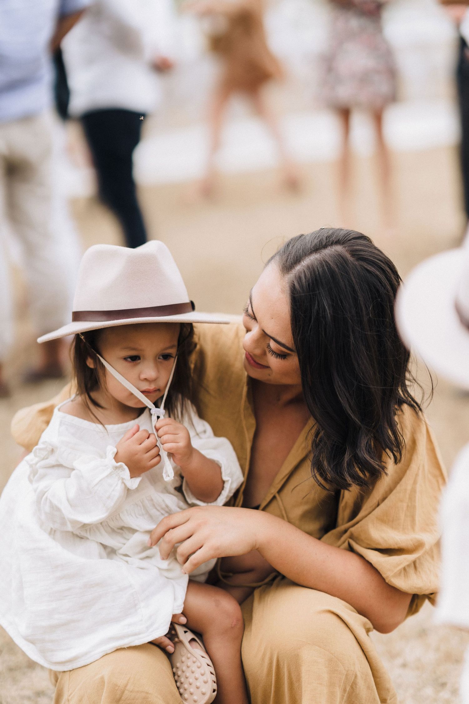 Tender outdoor family moment captured in warm tones with a parent and child sharing sweet interactions.