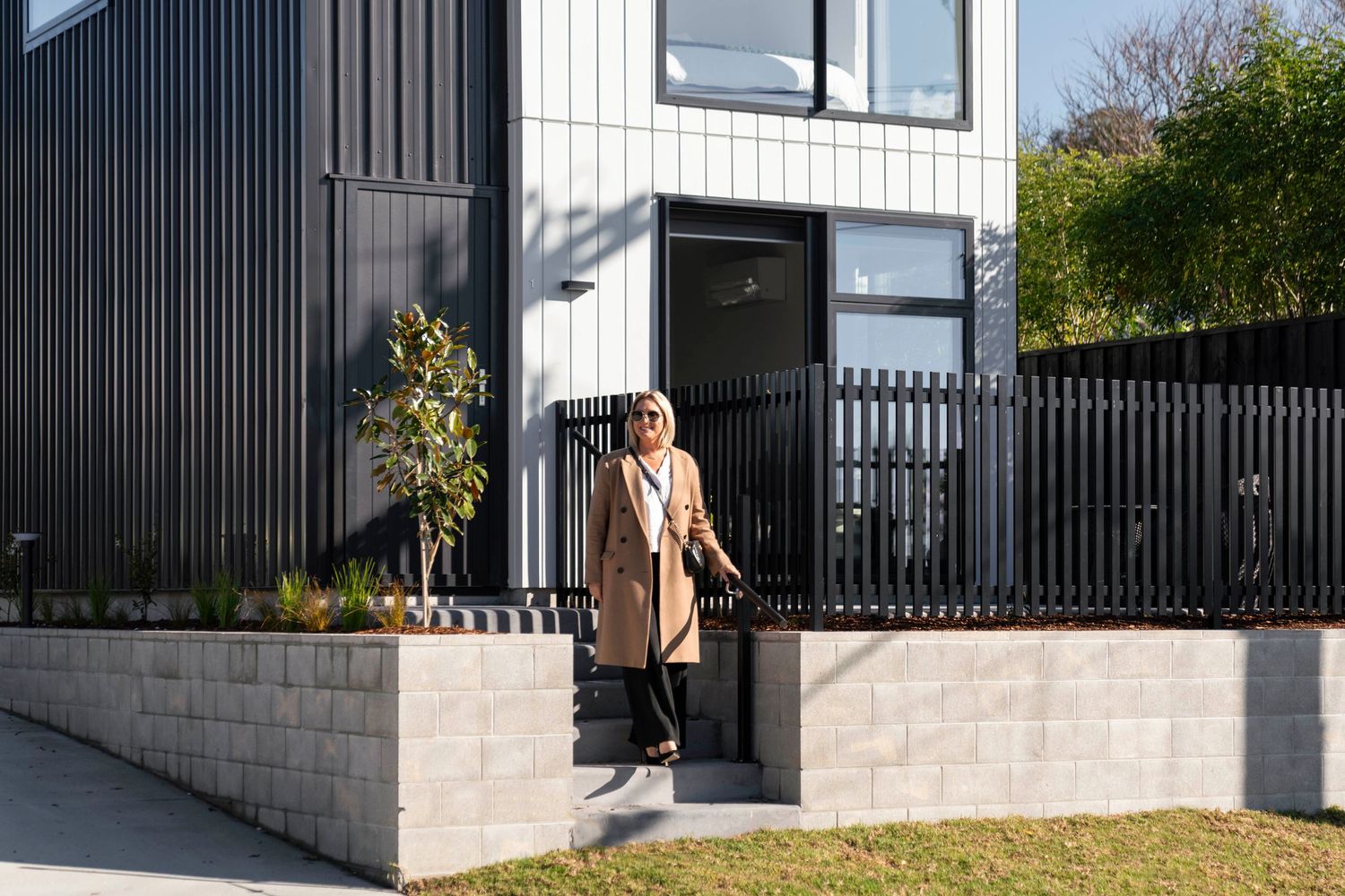Modern black vertical siding exterior with white trim and glass windows creates striking architectural contrast.