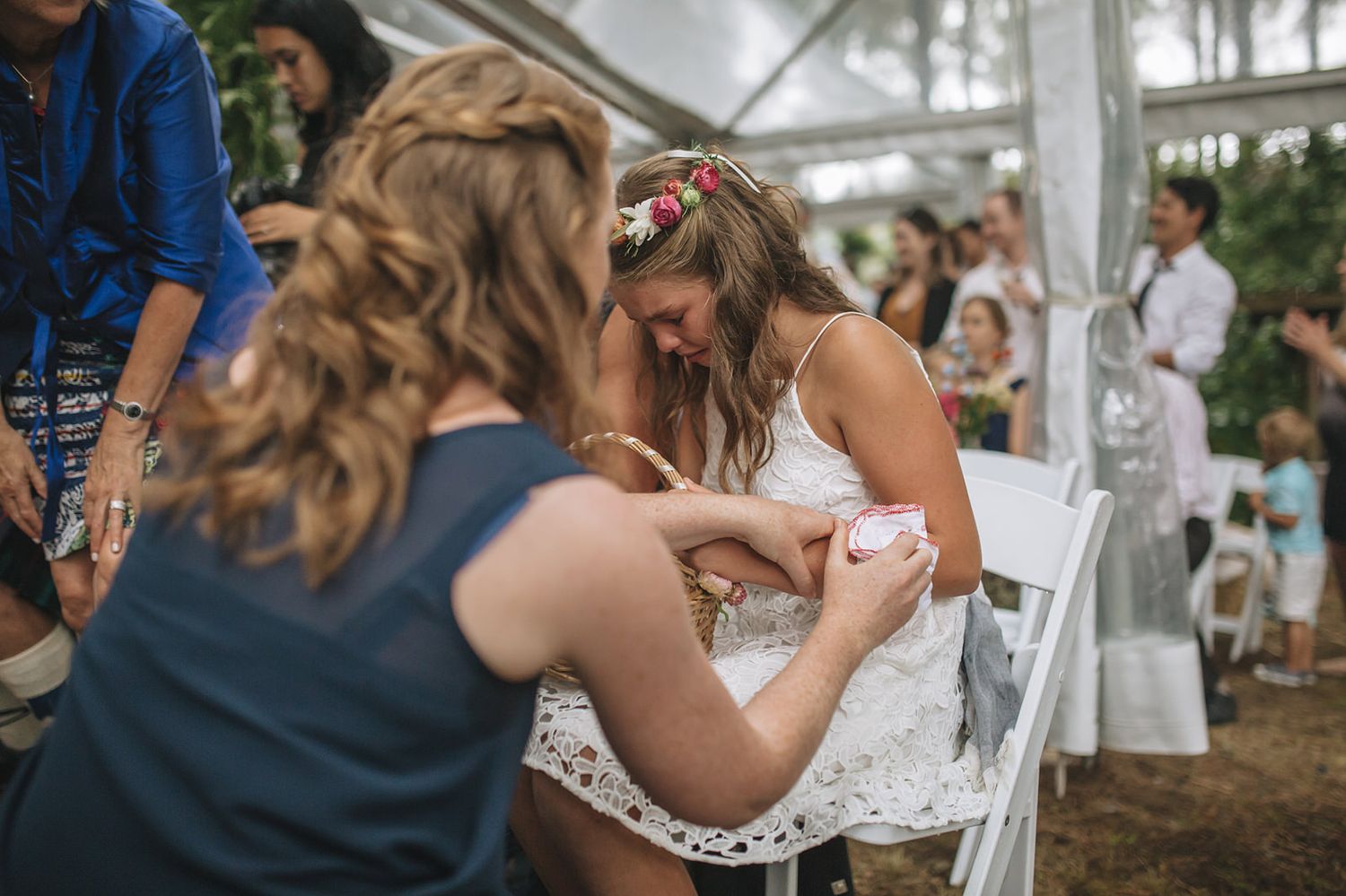 Wedding guests enjoying appetizers during an outdoor cocktail reception in wooded venue.